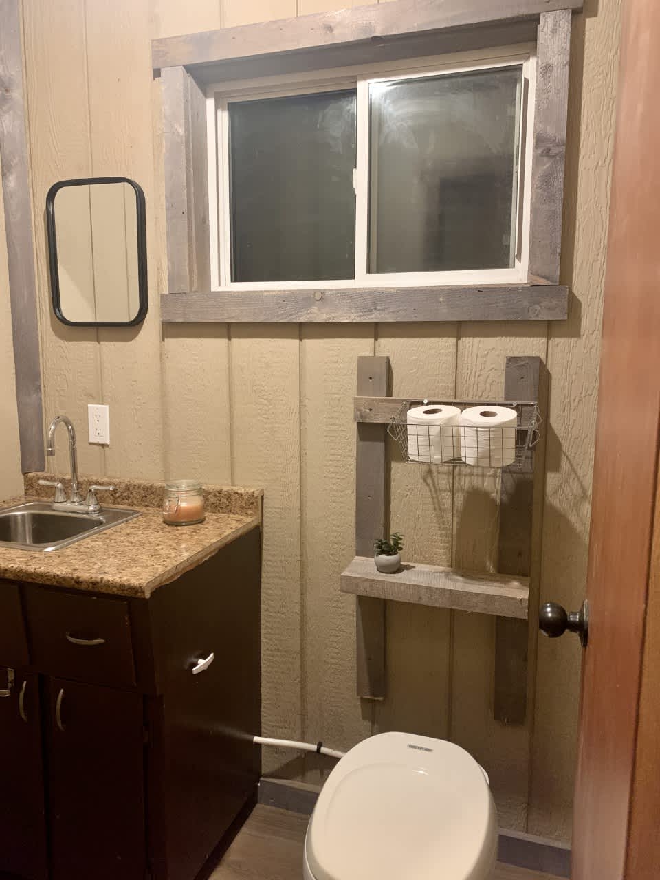 Small half bath with a flushable camper toilet. Needs water in the winter to flush.