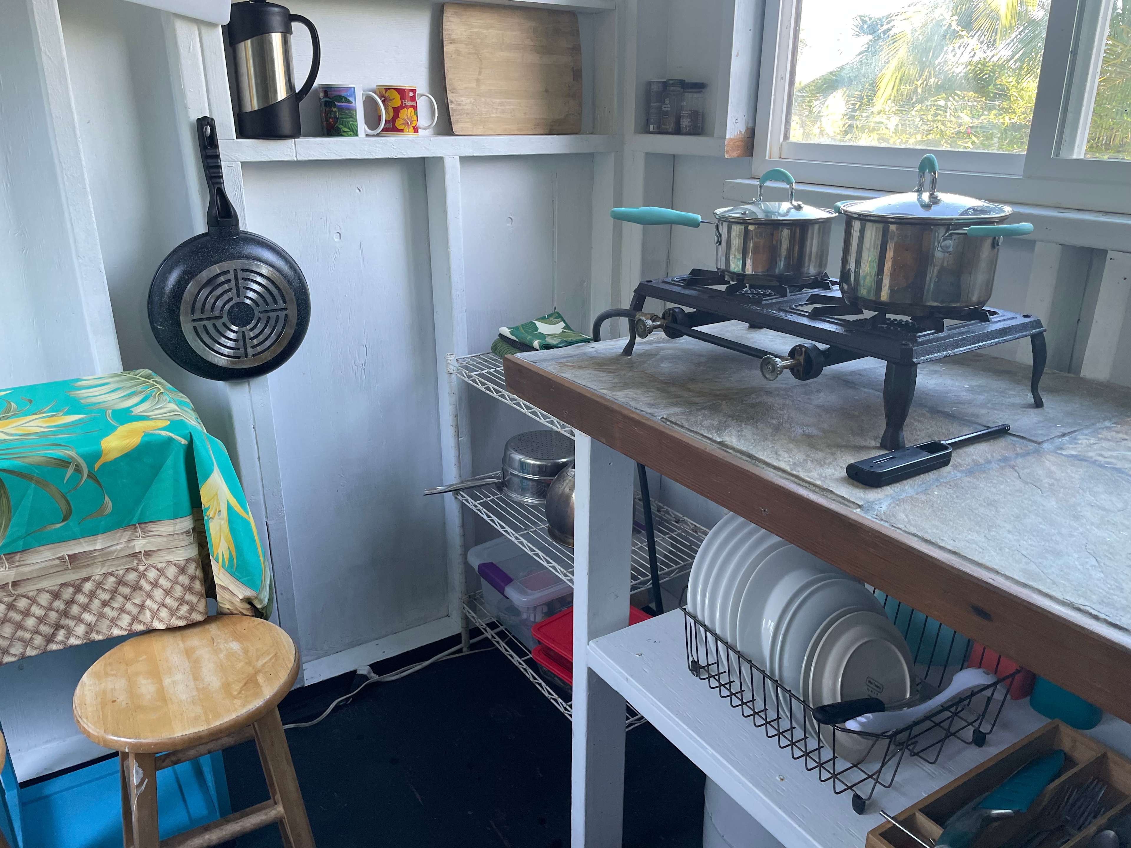 Separate kitchen with two burner stove, electric cooler and the basics.
