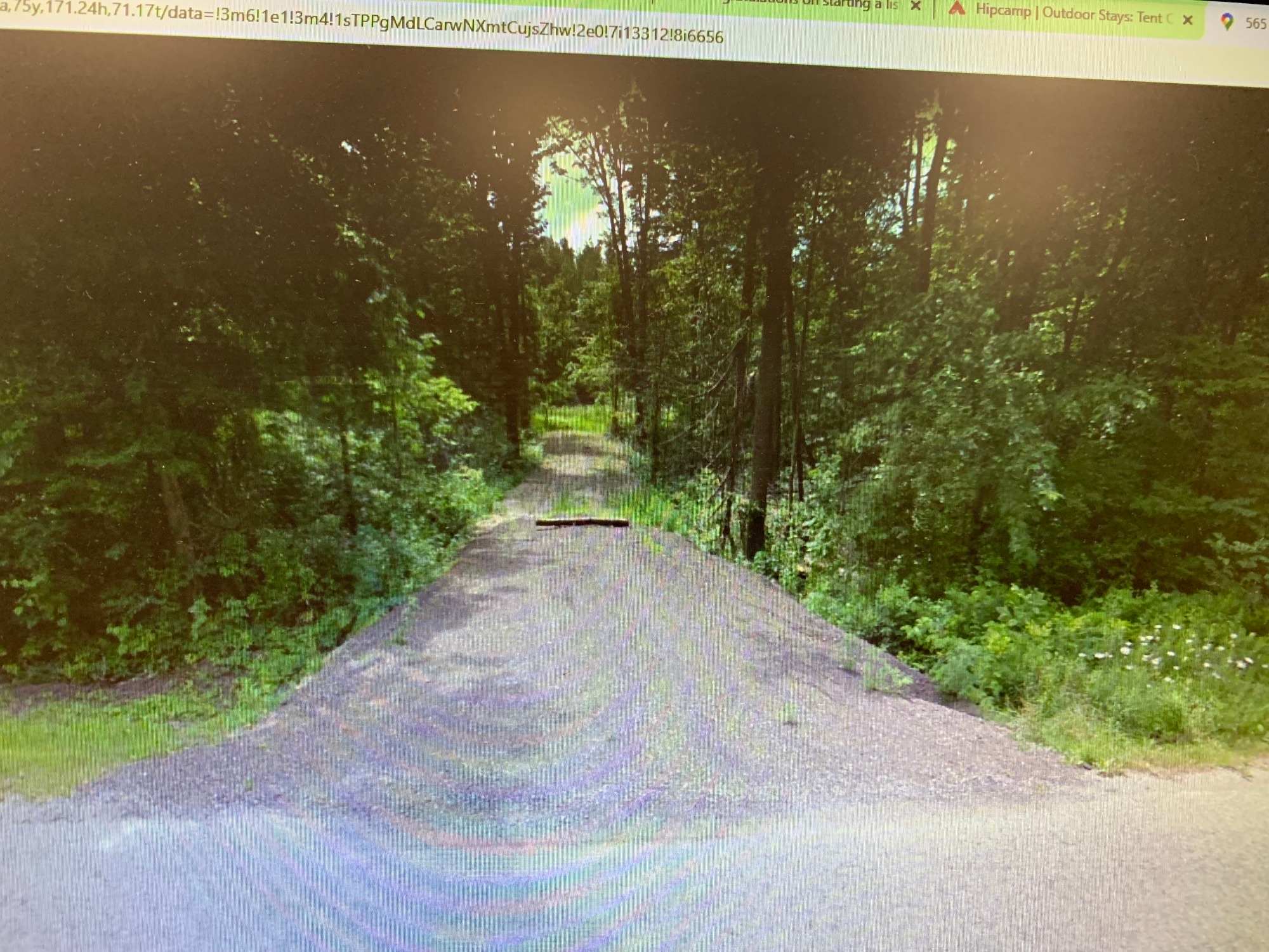 This is a view from the road.  The log across the private driveway is not there.