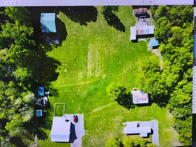site 4  upper right corner near workshop  tent, small RV or trailer
