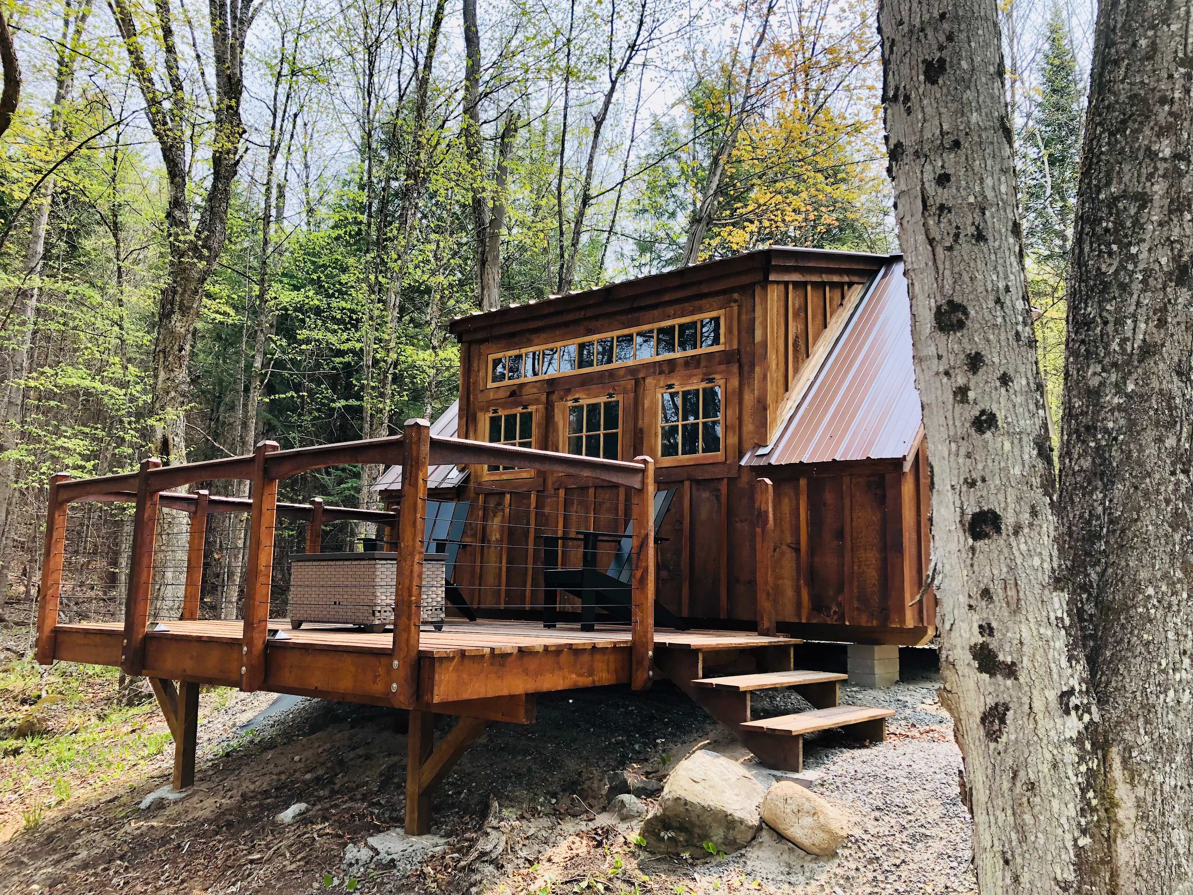 Outside looking up at tiny cabin from driveway
