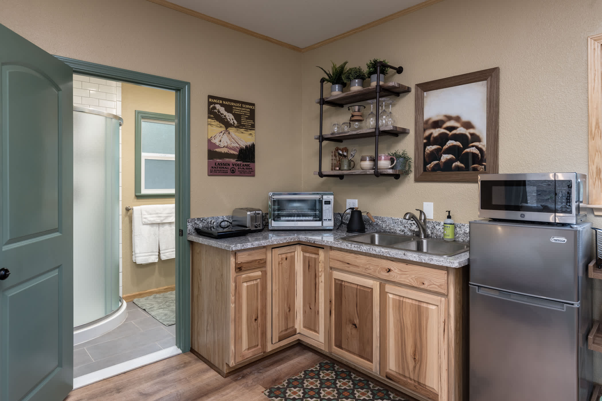 Kitchenette includes refrigerator, sink, hot plate, large toaster oven, microwave, kettle, pour over, Nespresso machine, dishes, and cookware. 