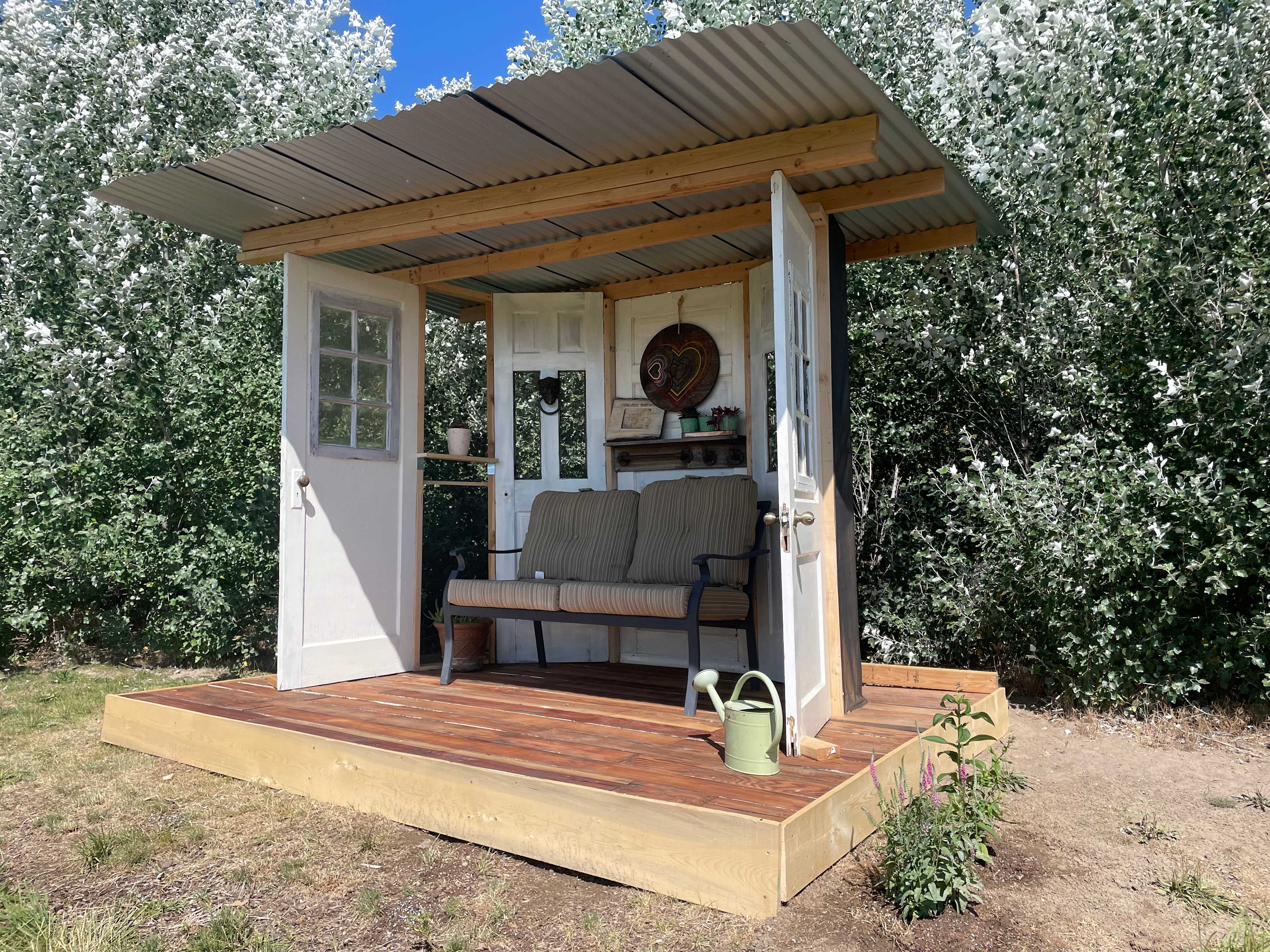 New standalone patio made primarily from reclaimed wood as well as doors and windows from 80-100yr old houses from Boise's North End provides a new place to sit and enjoy the view and the wildflowers