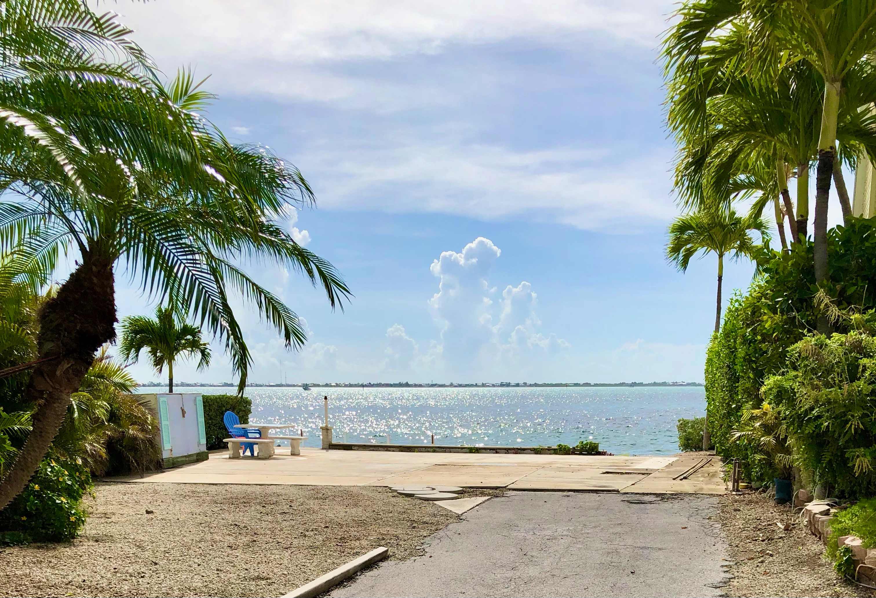 This is the RV lot from the street.  Lots of tropical plants and trees help keep you private.  The 57 foot seawall is straight ahead.
