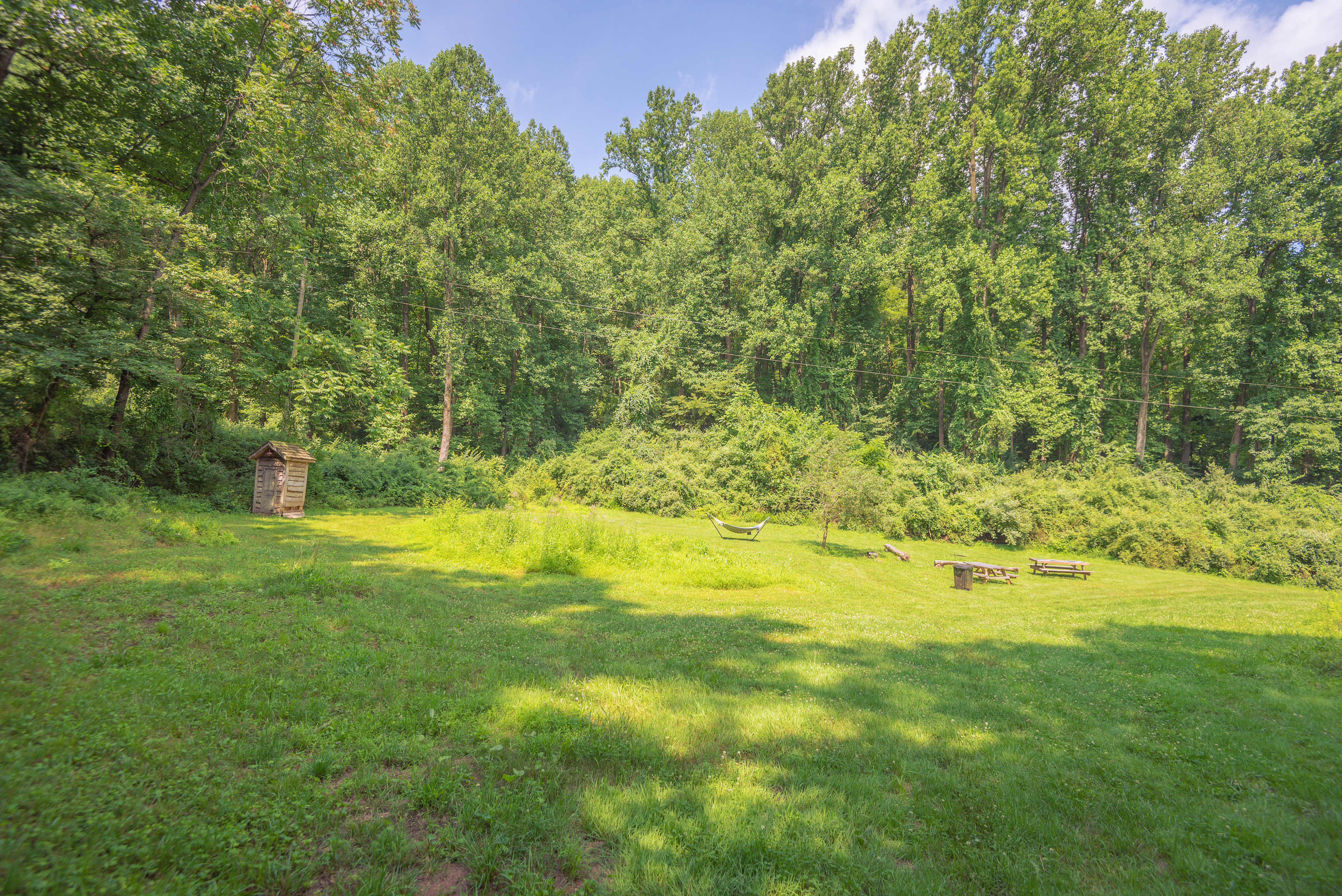 Site #2 is a huge site with a ton of space available for a large group. It has a private outhouse, hammock, firepit, and entrance into the woods for hiking.