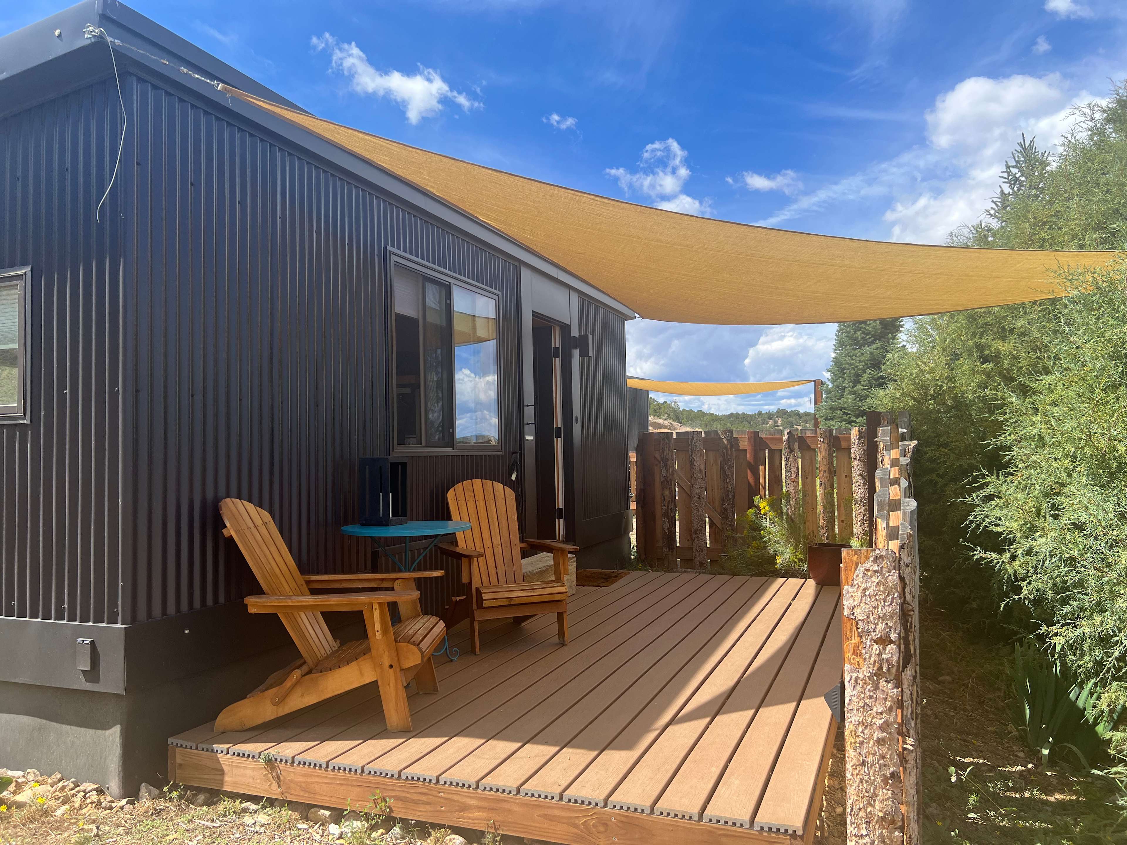 A welcoming scene on the tiny house porch, nice and private from the other sites