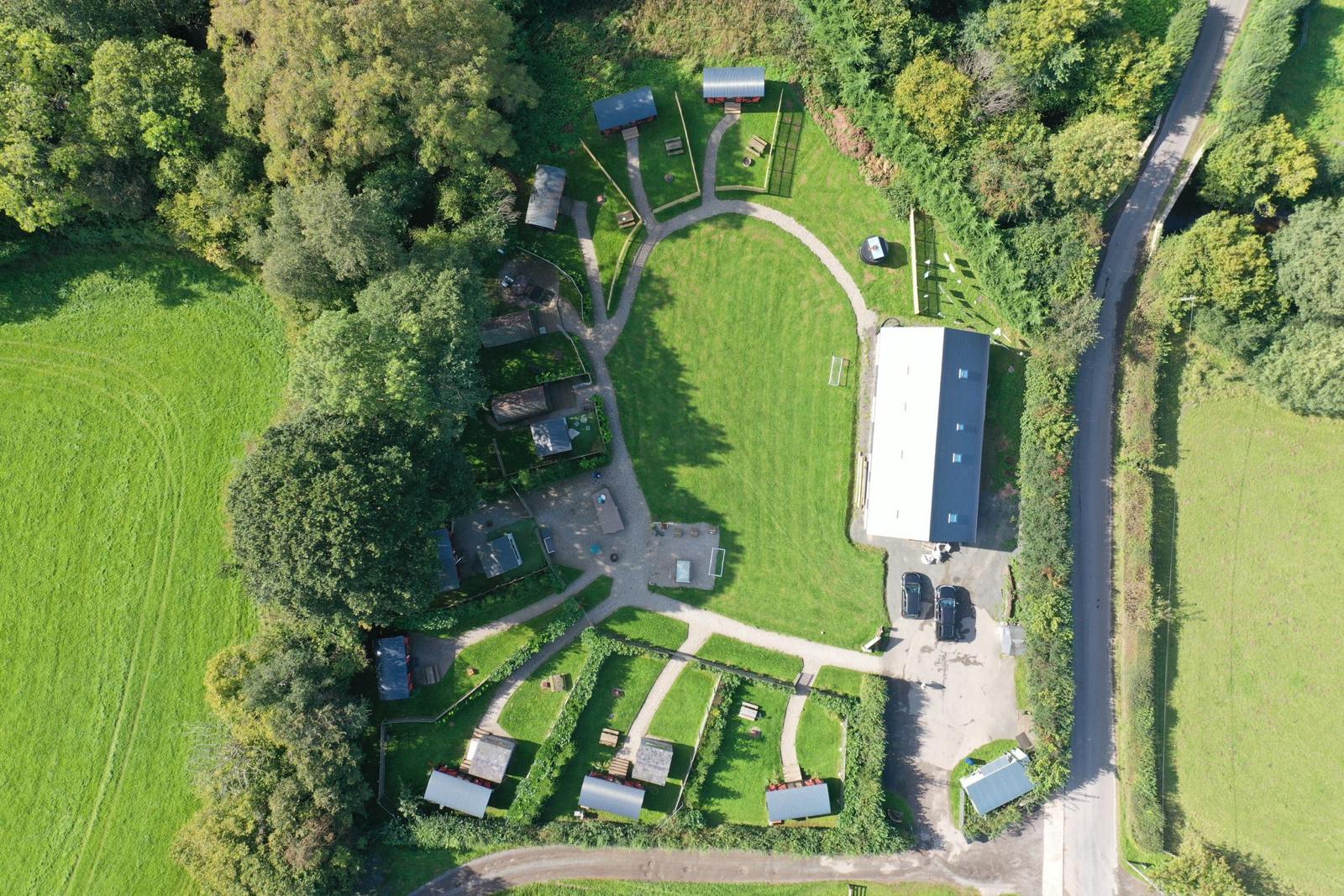 Over Veiw of site each with private gardens. 
8 Carriages 2 log pods, large social space. 