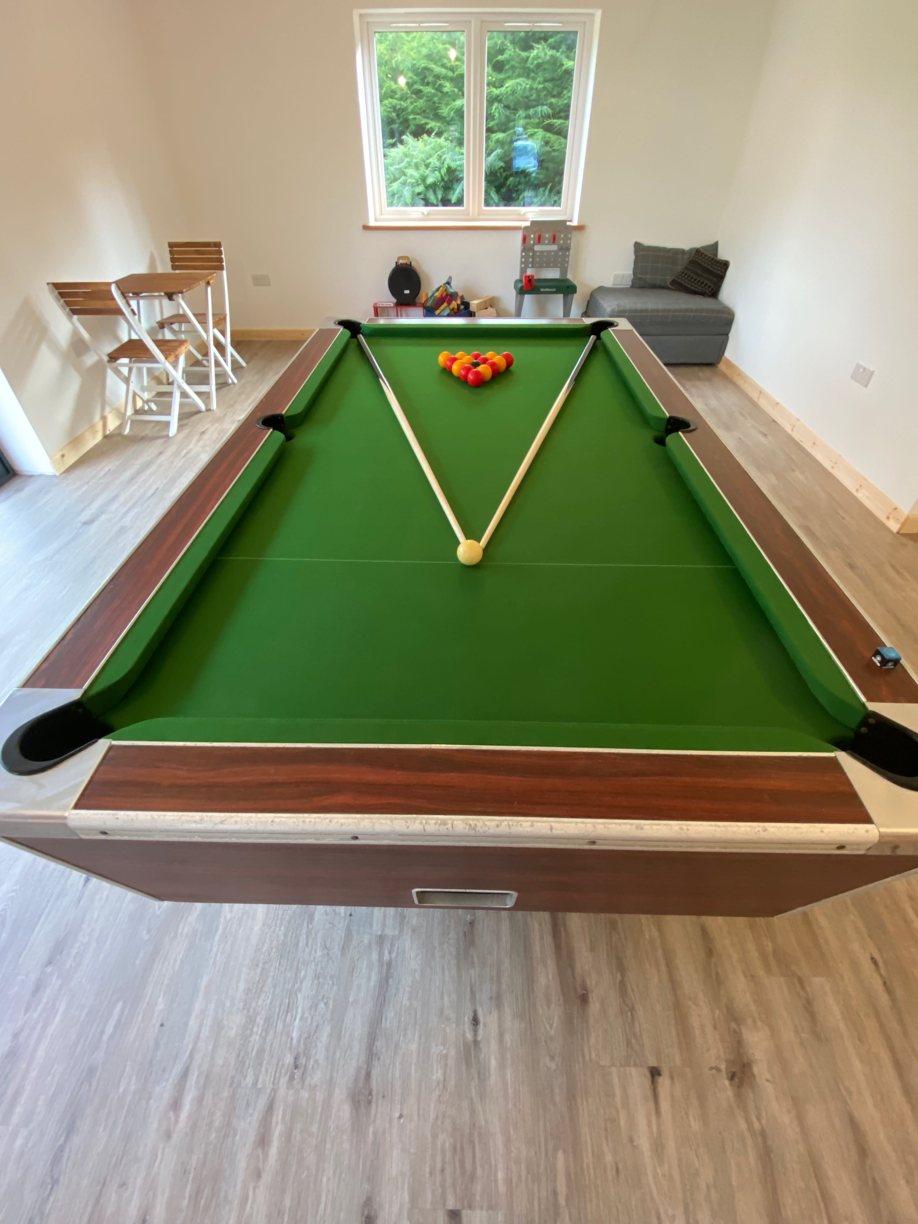 pool table and football table in social games room. 