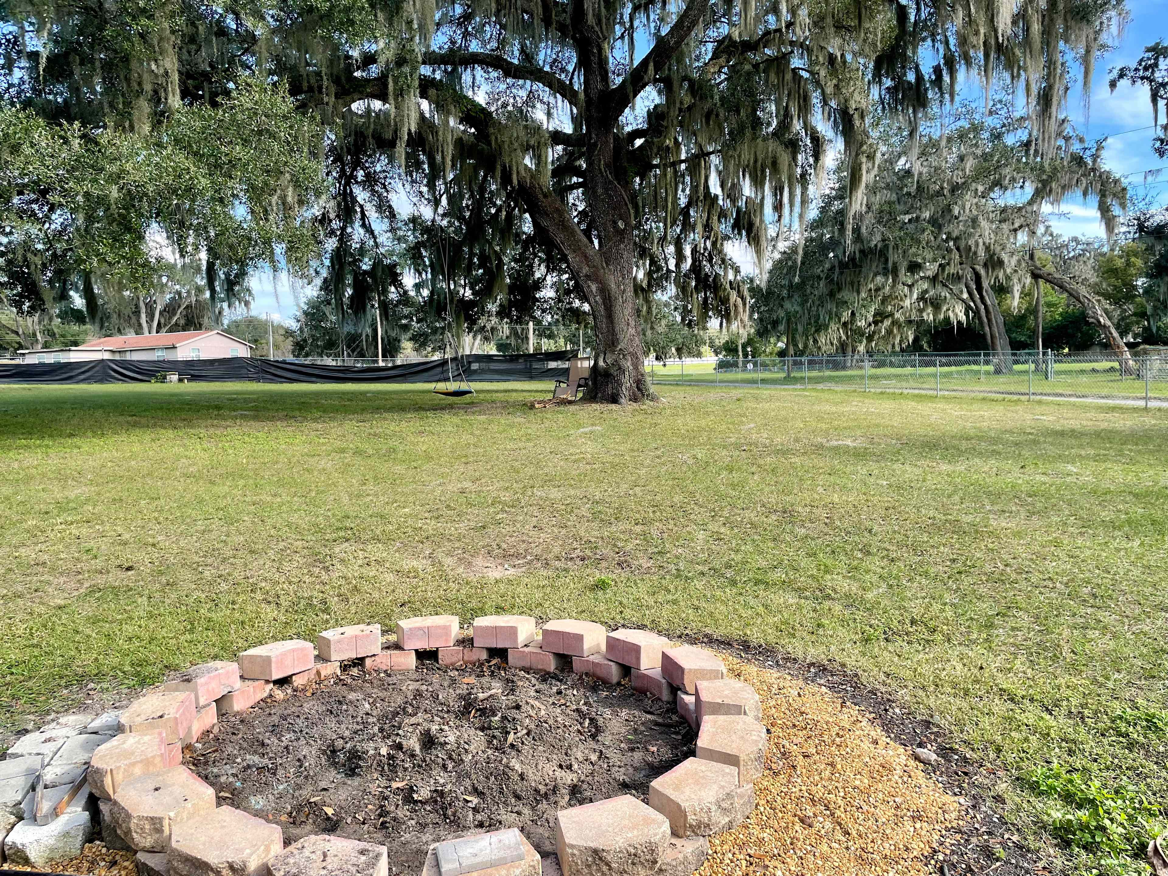 Gather around a splendid bonfire amidst ancient oak tree