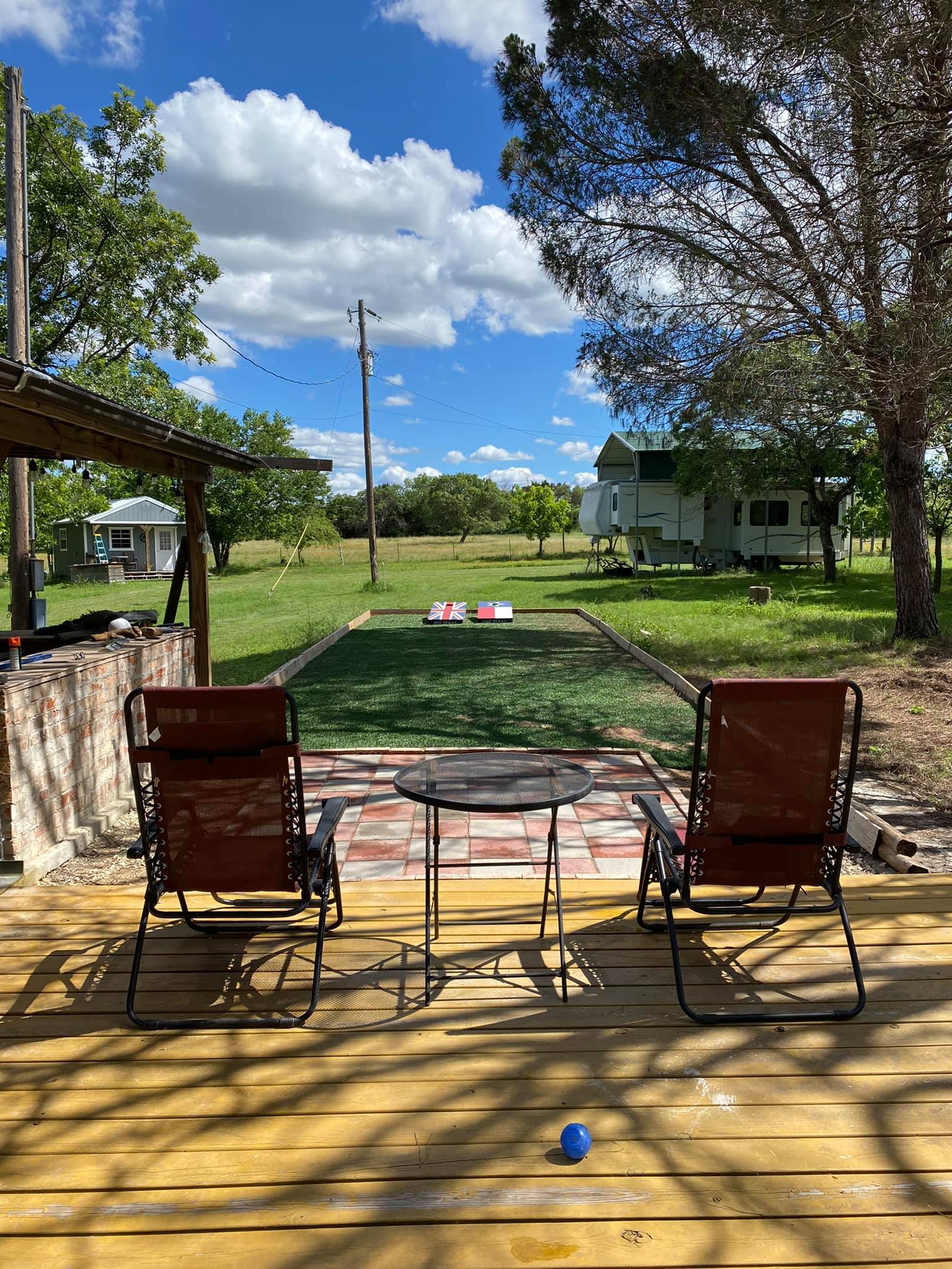 Deck and sport court facing covered RV spot (Summer)