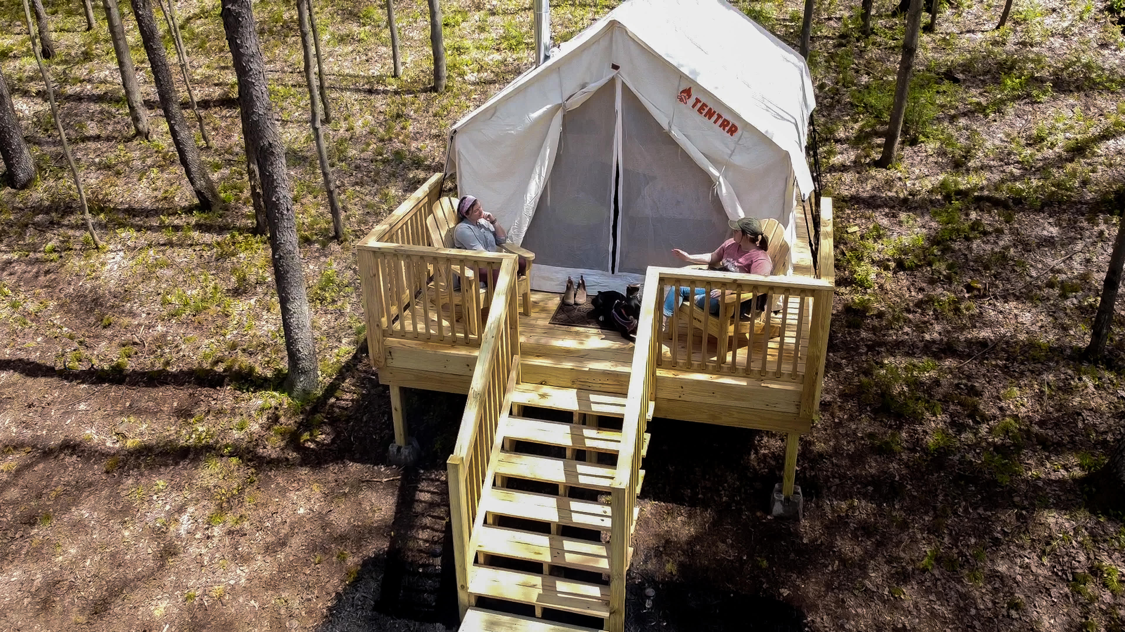 Relax and watch for deer from Adirondack chairs on the tent deck