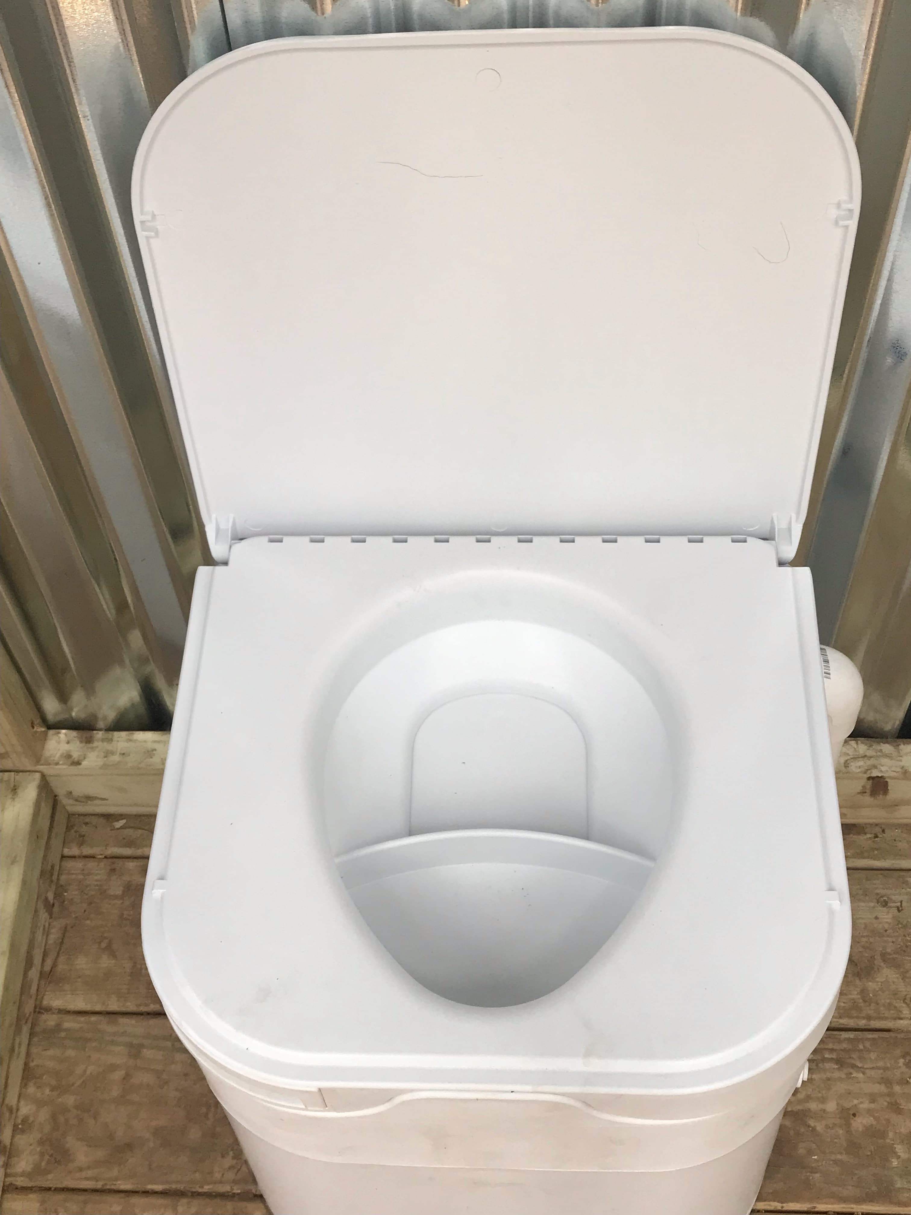 Pee goes in front.  Guys... please sit down !!