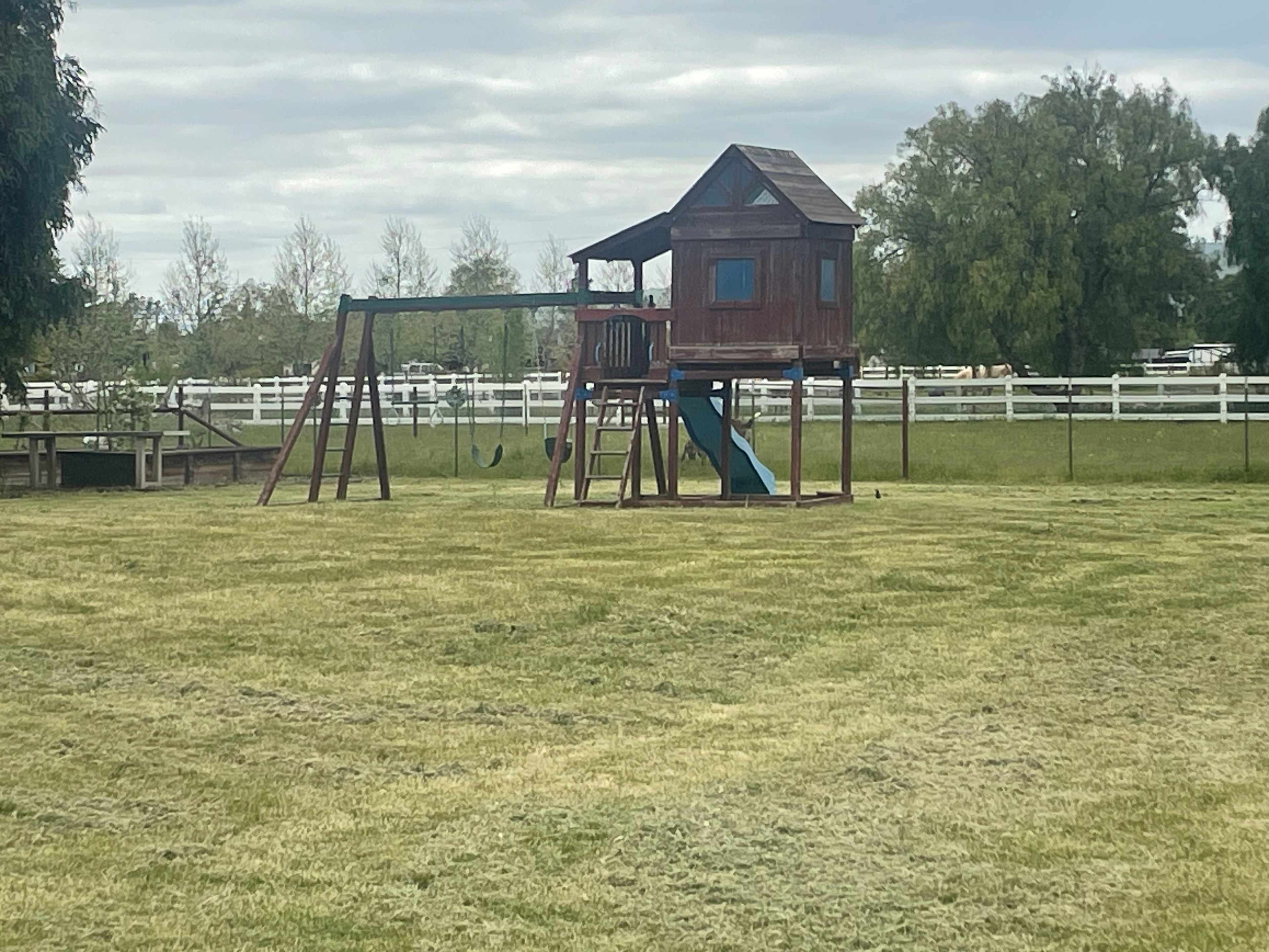 Kids play structure with swings, bar, slide and clubhouse! 