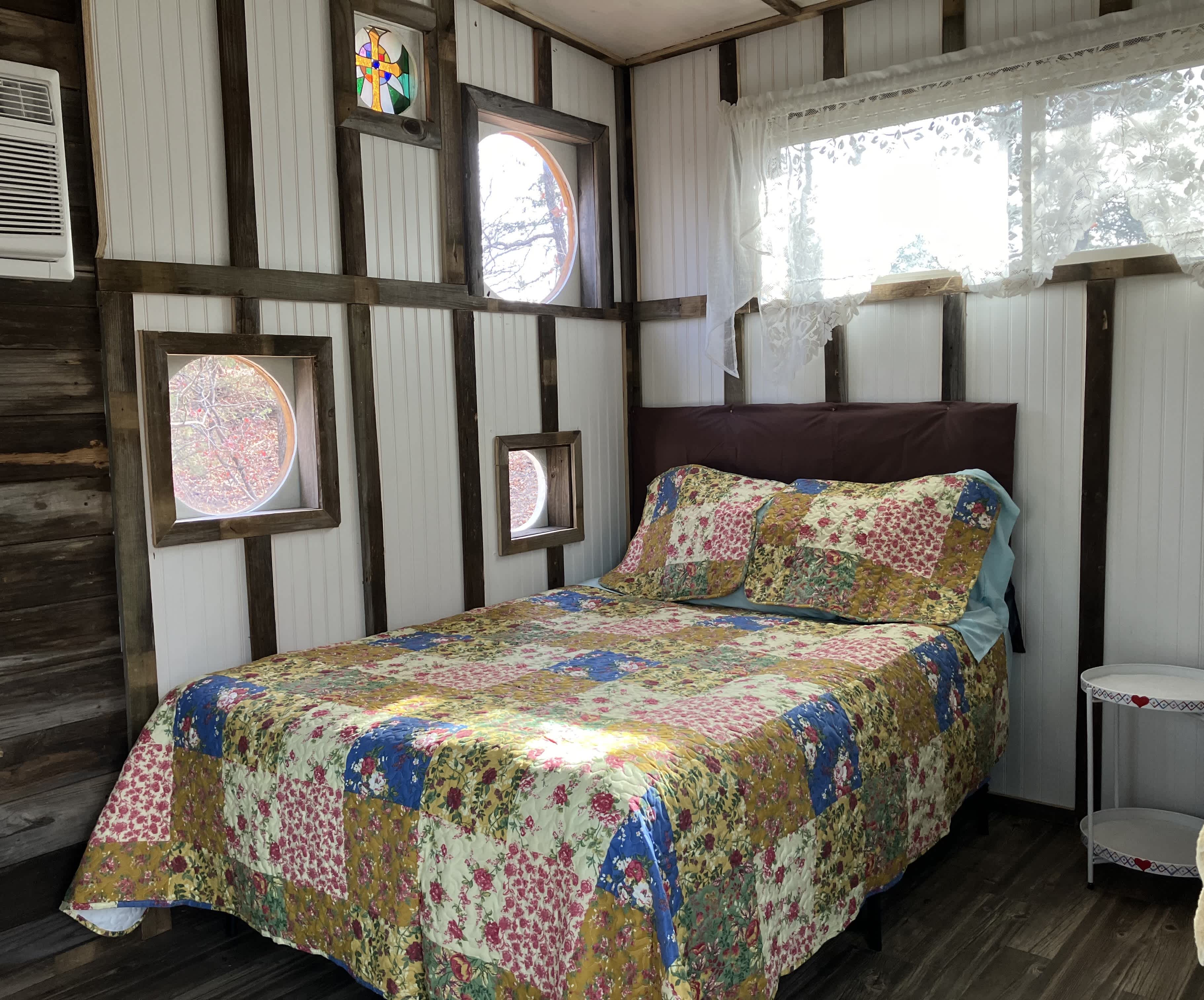 Cozy sleeping in the Tree House with lots of windows to view the Forest.