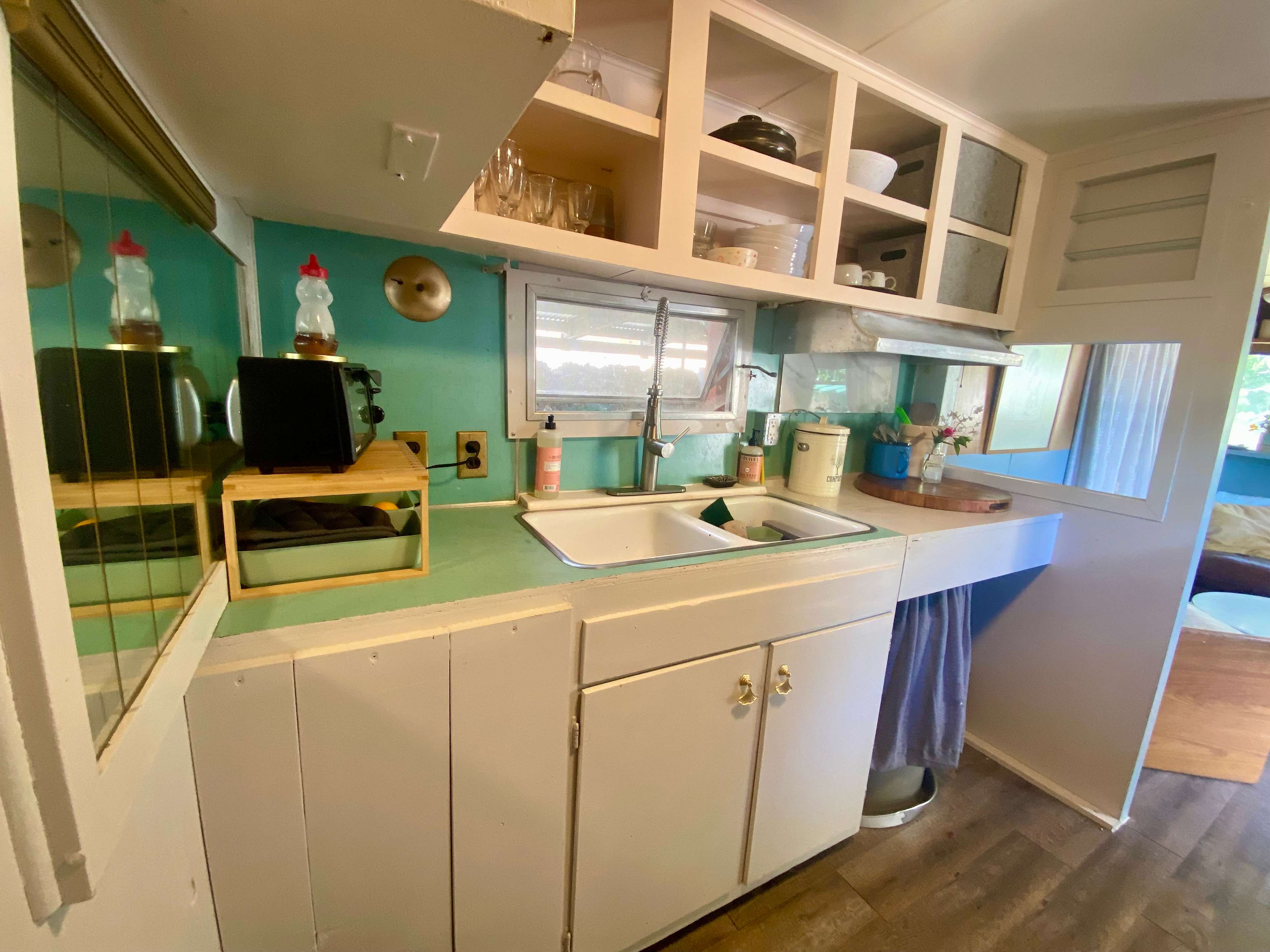 A small but functional kitchen.
Toaster, a fridge, double sink, and full oven. 
