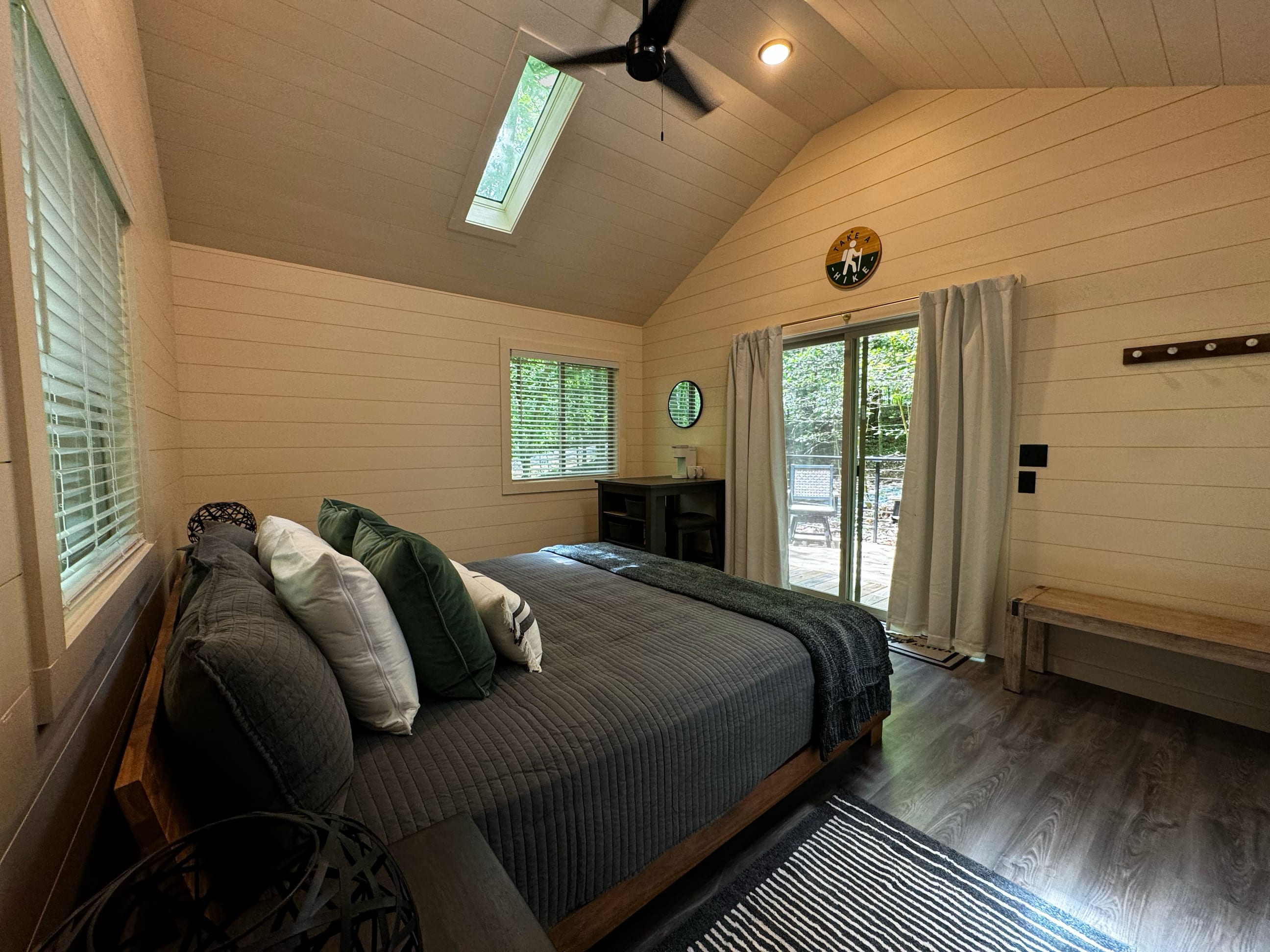 Dining Table/Desk complete with two stools for your convenience, Plush King-Sized Bed and Cozy Bench.