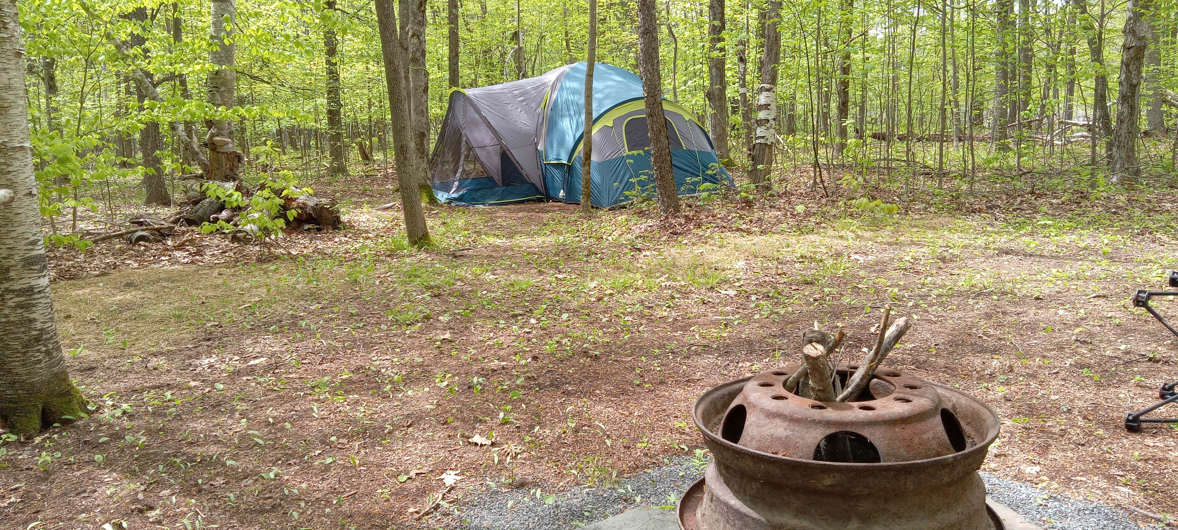 10 person  tent fire pit  cooking  area canopy  tent outside  toilet  and  shower extra spots  for personal  tents