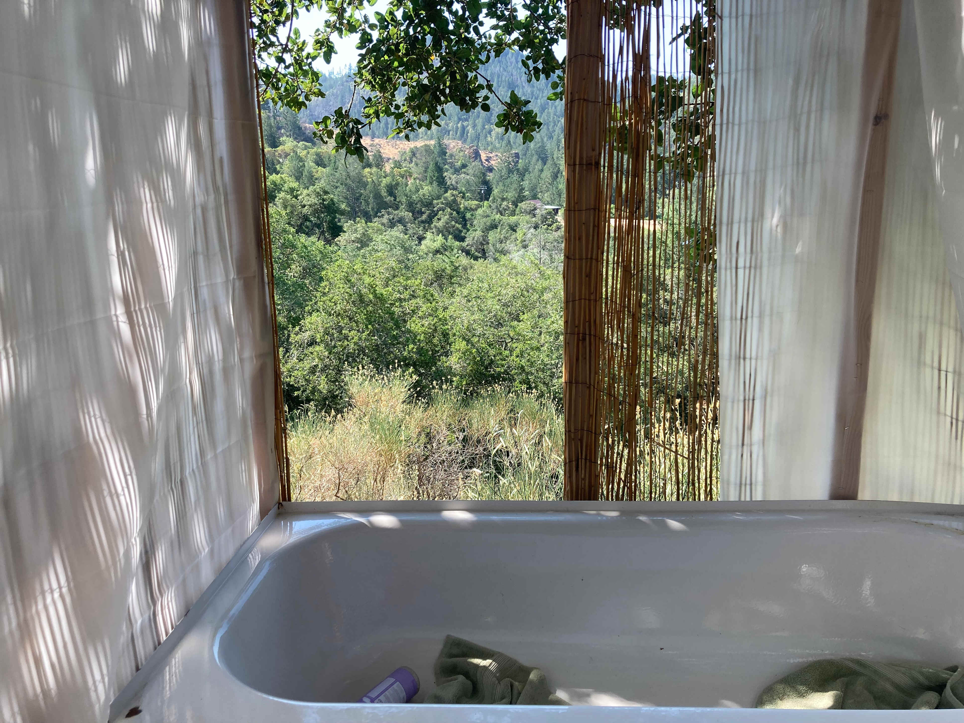The new shower/tub combo has a privacy screen all around, except for the one outlook where there are no visible houses. 