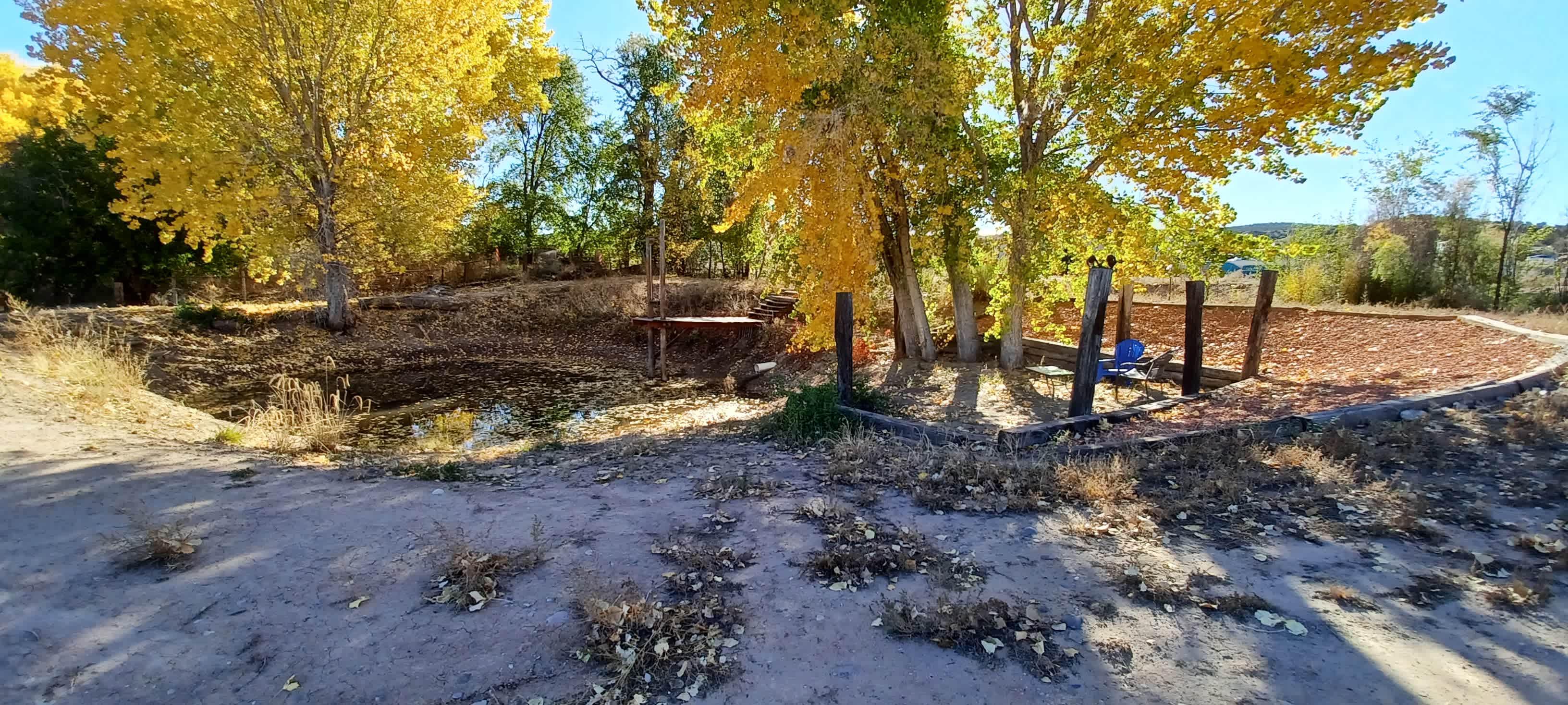 Ranch settiing landscaped with  a pond, swing and plenty of flat tent sites, running well water, electricity and 2 RV leveled pads with 30amp connecti
