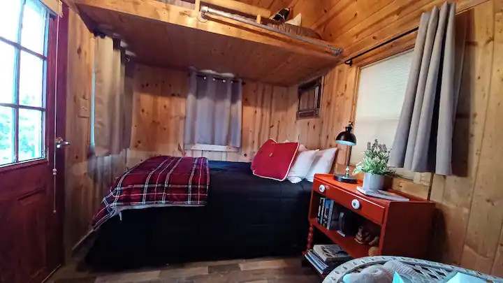THE HUGGERY BEDROOM.  Two guests can sleep in the cozy double bed, while two more younger people might want to try the overhead loft beds. 