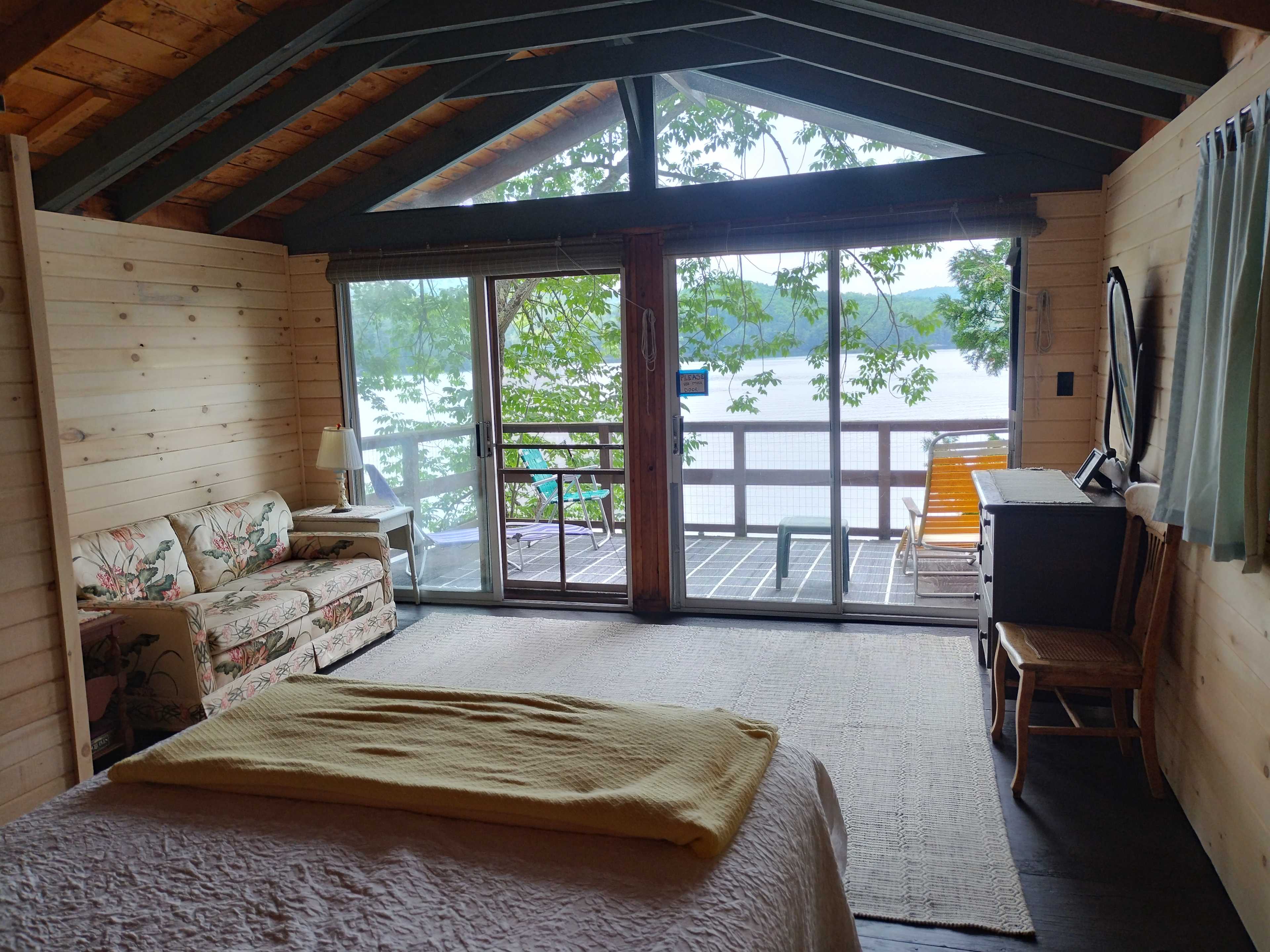 The bedroom and upper deck of Chickadee Cottage.  