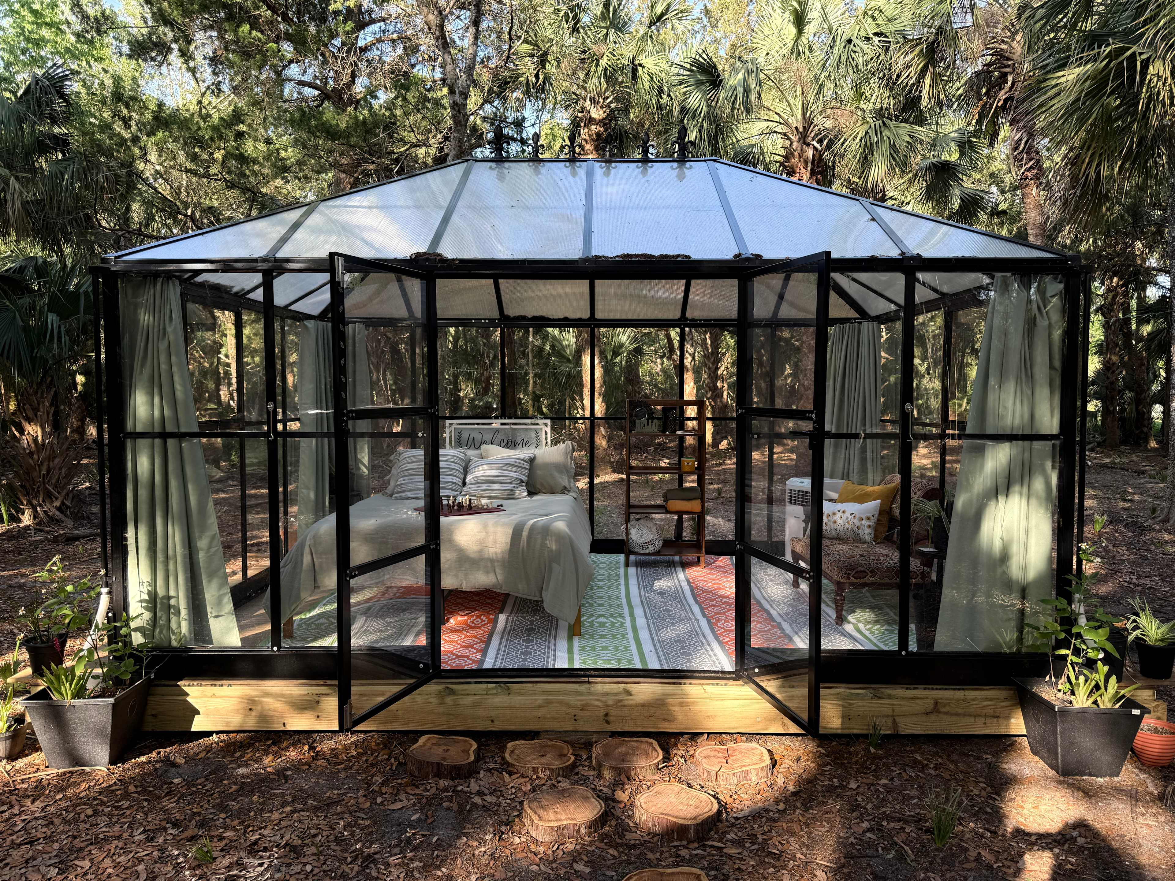 The Glamping Greenhouse with curtains open.