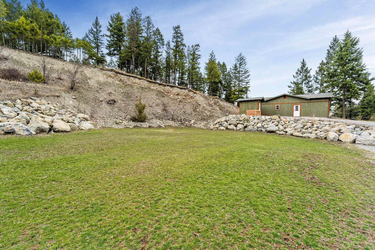 These pictures give a general idea of the property. Since they were taken, roads have been cut and campsites added higher up. Most have lake views. The cliff was eliminated to make things safer for campers.