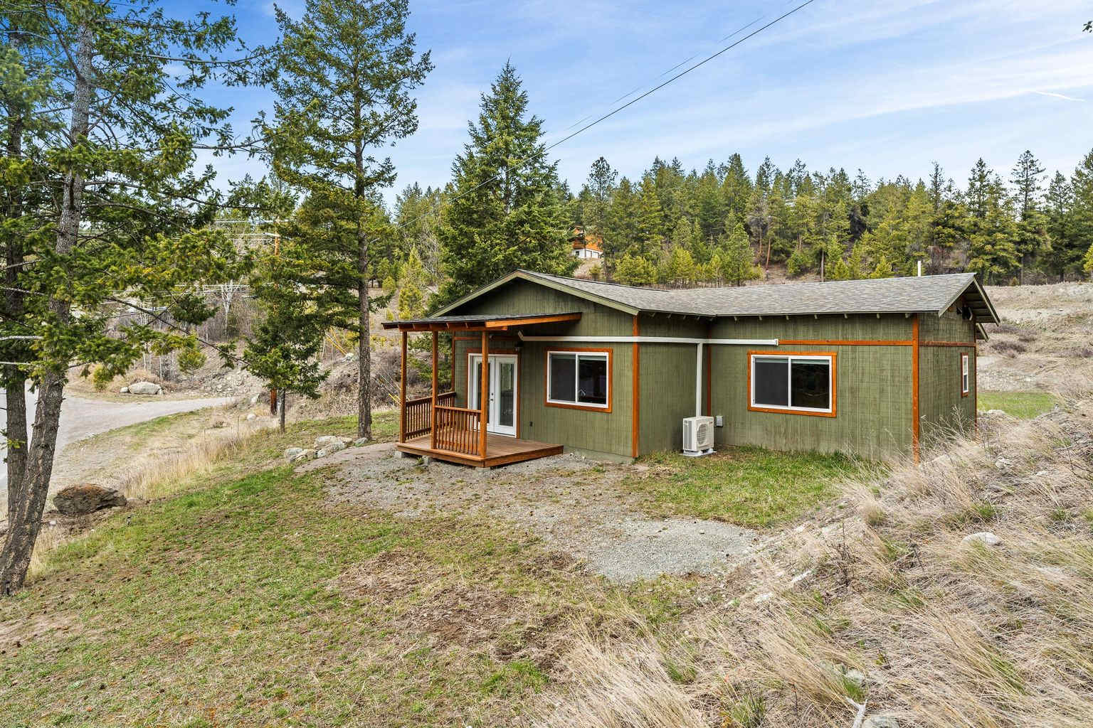 The Love Shack, view from the front. The deck has been extended, and a spa is being installed outside the master bedroom. There is a heat pump that provides heating and cooling. The adjacent hillside is a flower, herb, berry and fruit tree garden that has been carved into it, channeling the water flow to each section, as it flows downhill. 