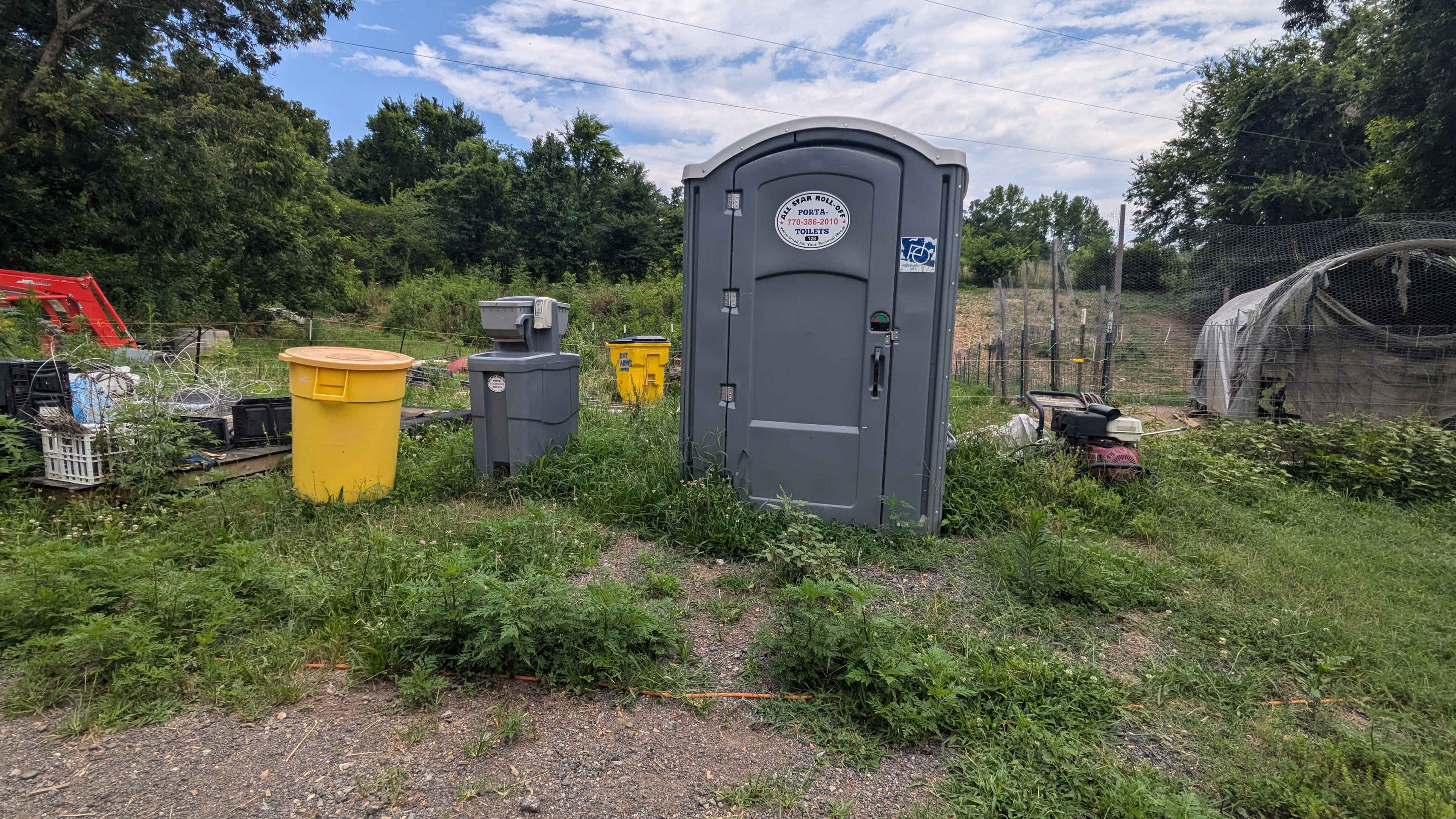 Porta-potty and hand wash station in the barnyard