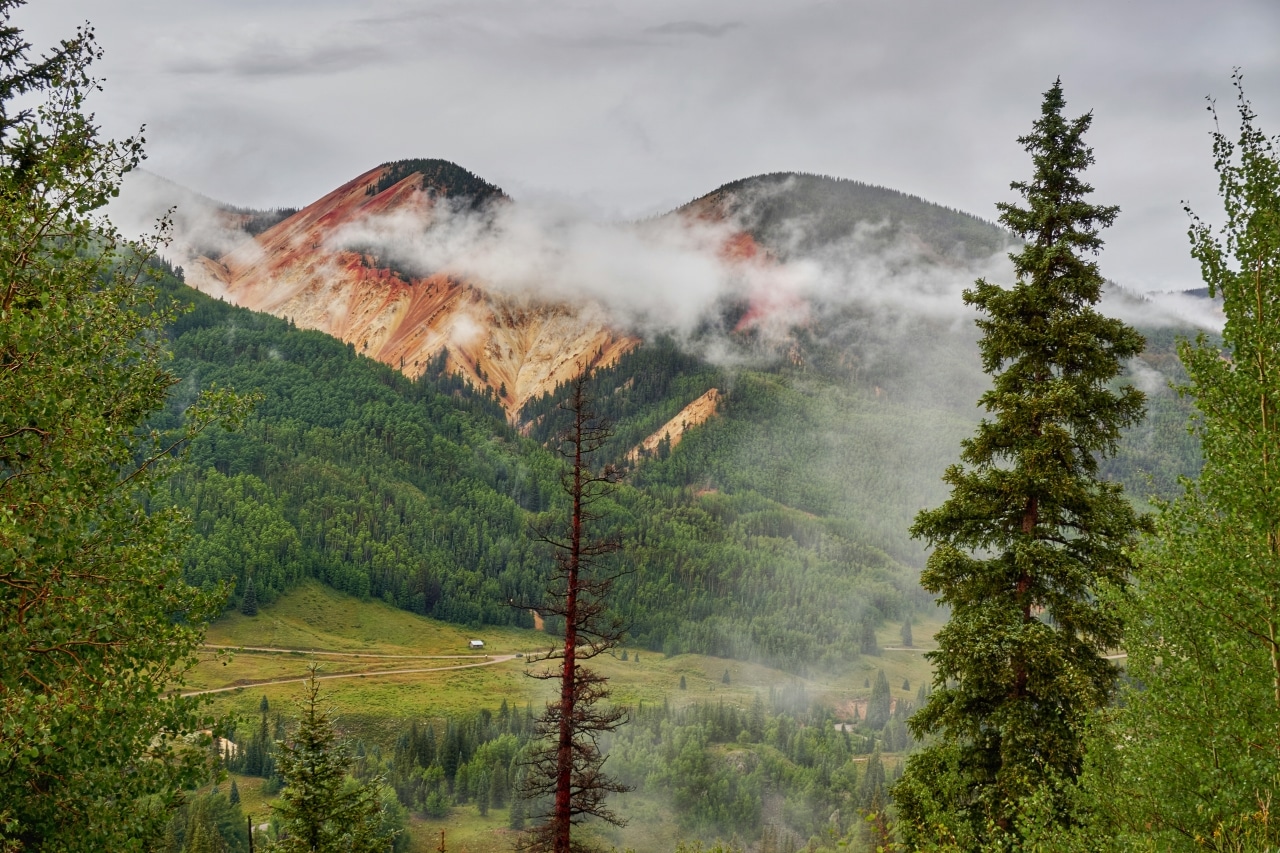 Big Red Mountain and Little Red Mountain as seen from Stunner Pass. The brilliant red and yellow hues come from the high mineral content found in the mountains.