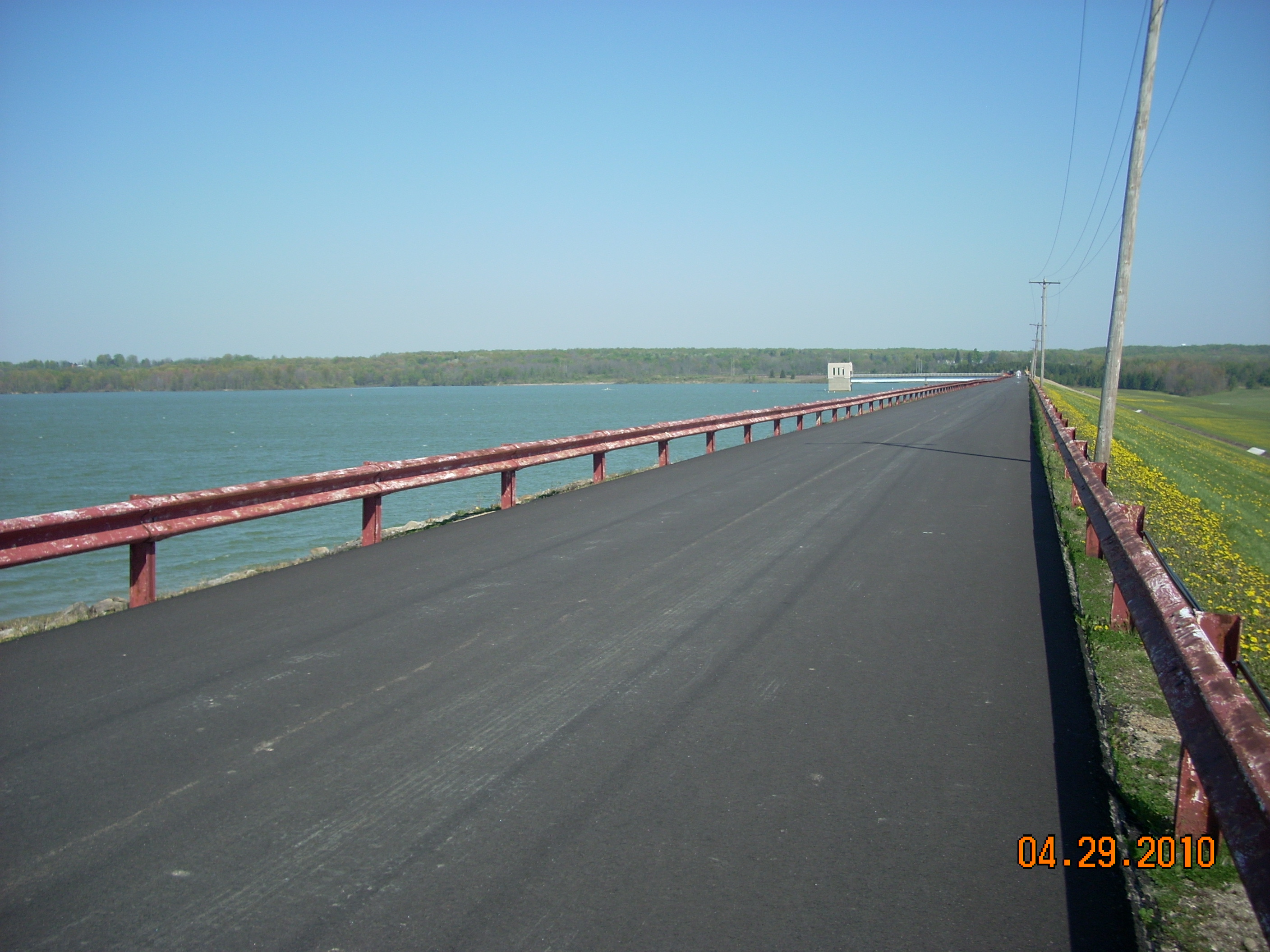 the view of the lake and reservoir from the top of the rolled-earth dam
