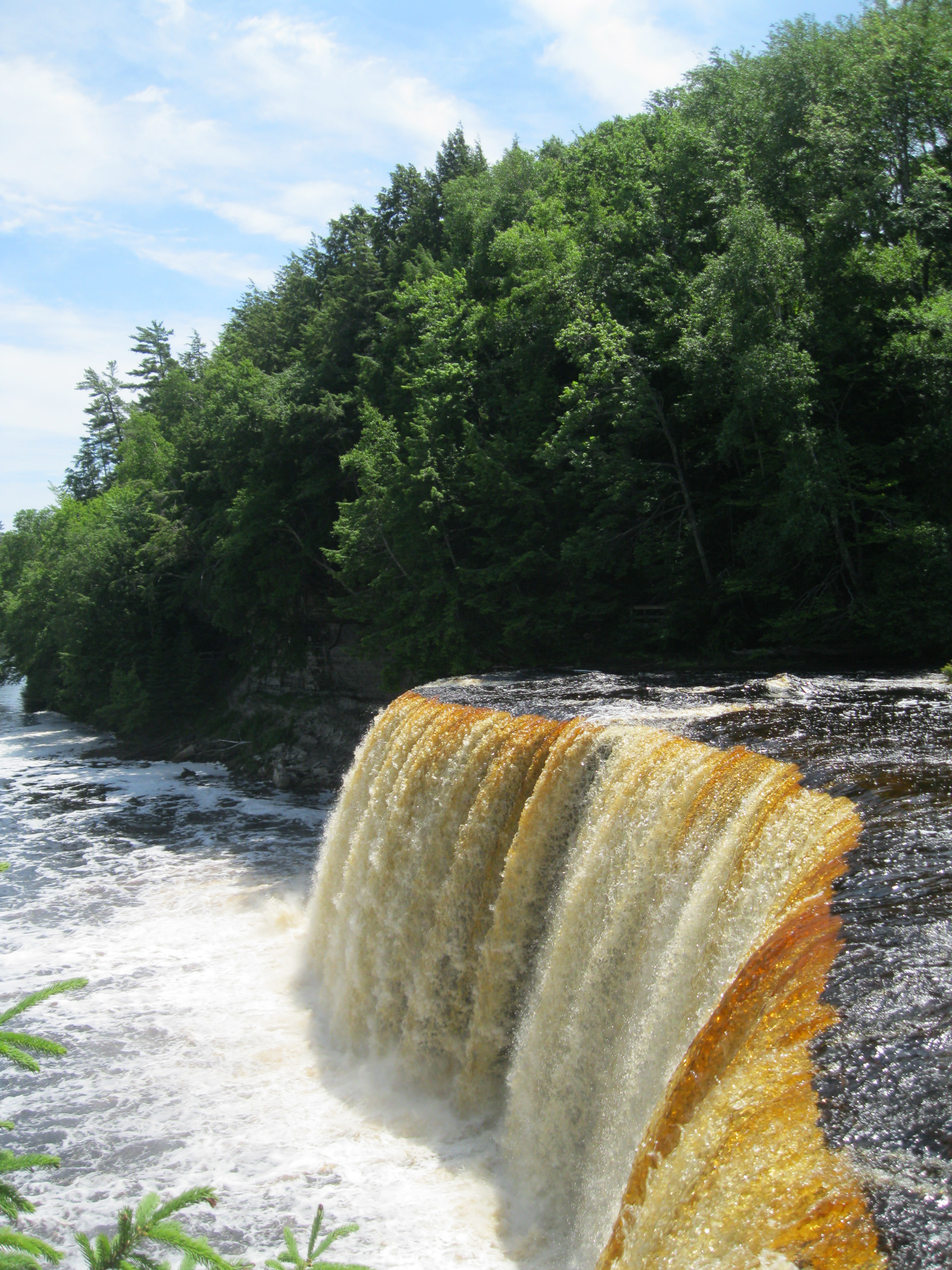 Look past the falls and down the river.