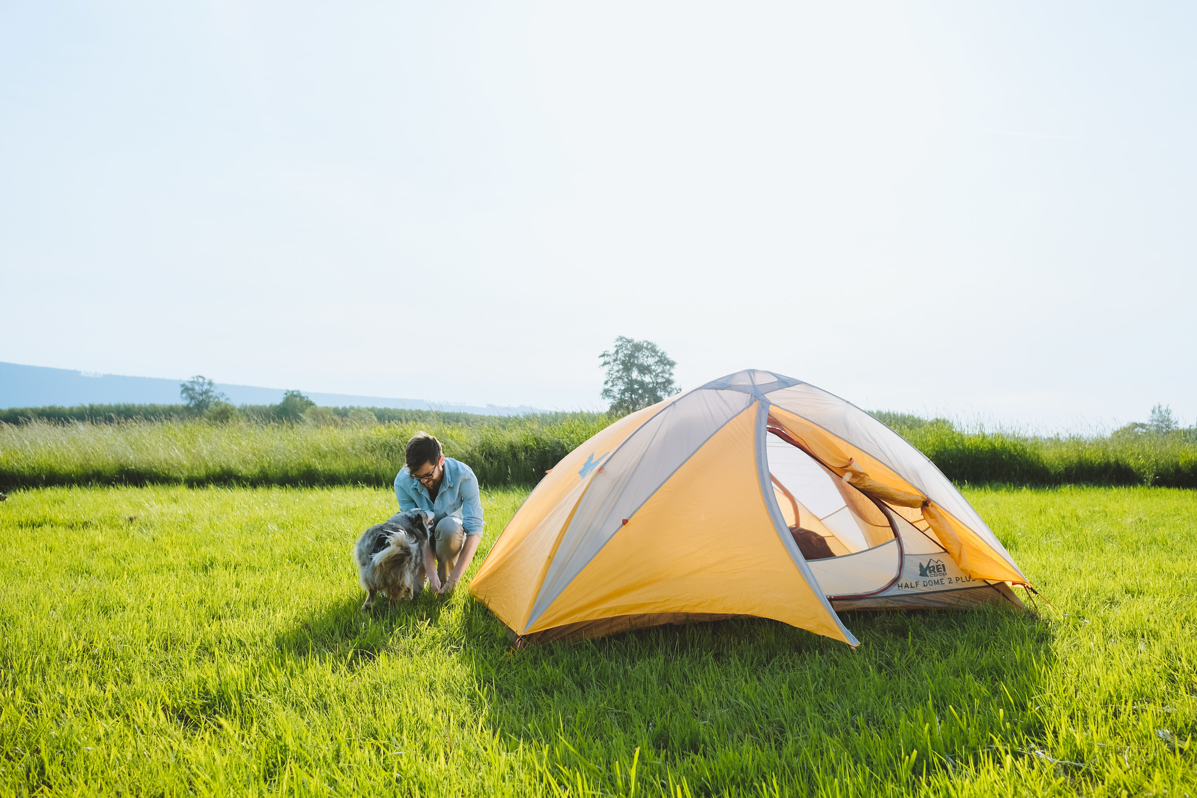 Pitching the tent with Gaston, the farm dog, helping out. 
