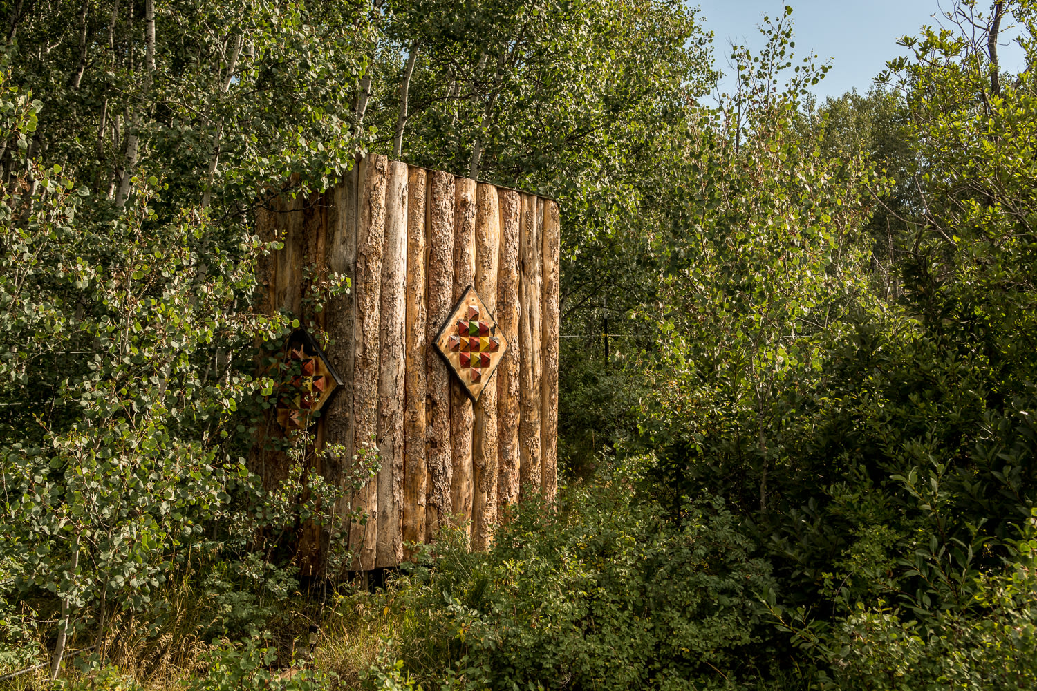 The outdoor toilet + solar shower as seen from the short walking path from Campy.