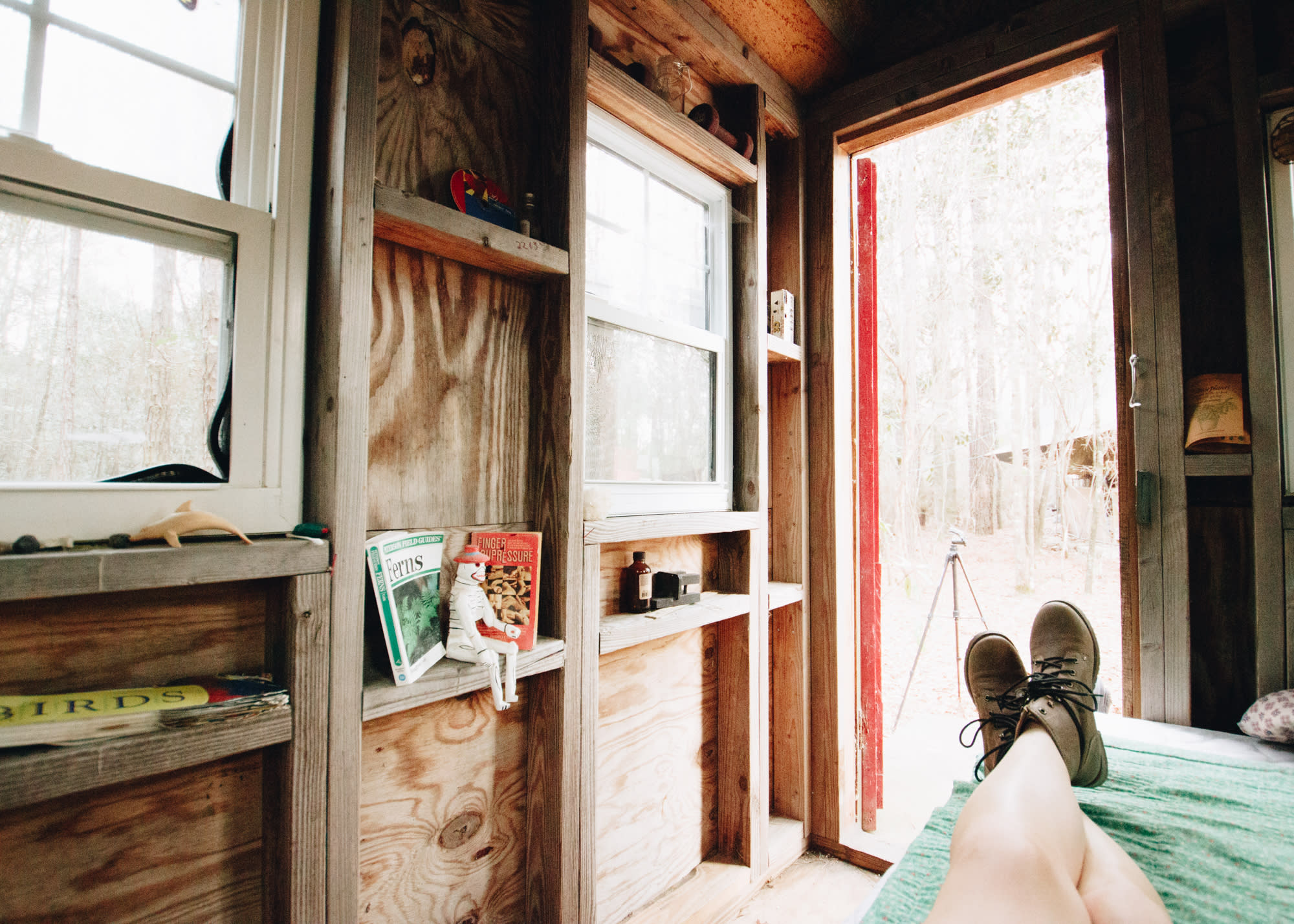 Little trinkets, books, and a few CDs line the walls of this tiny cabin.