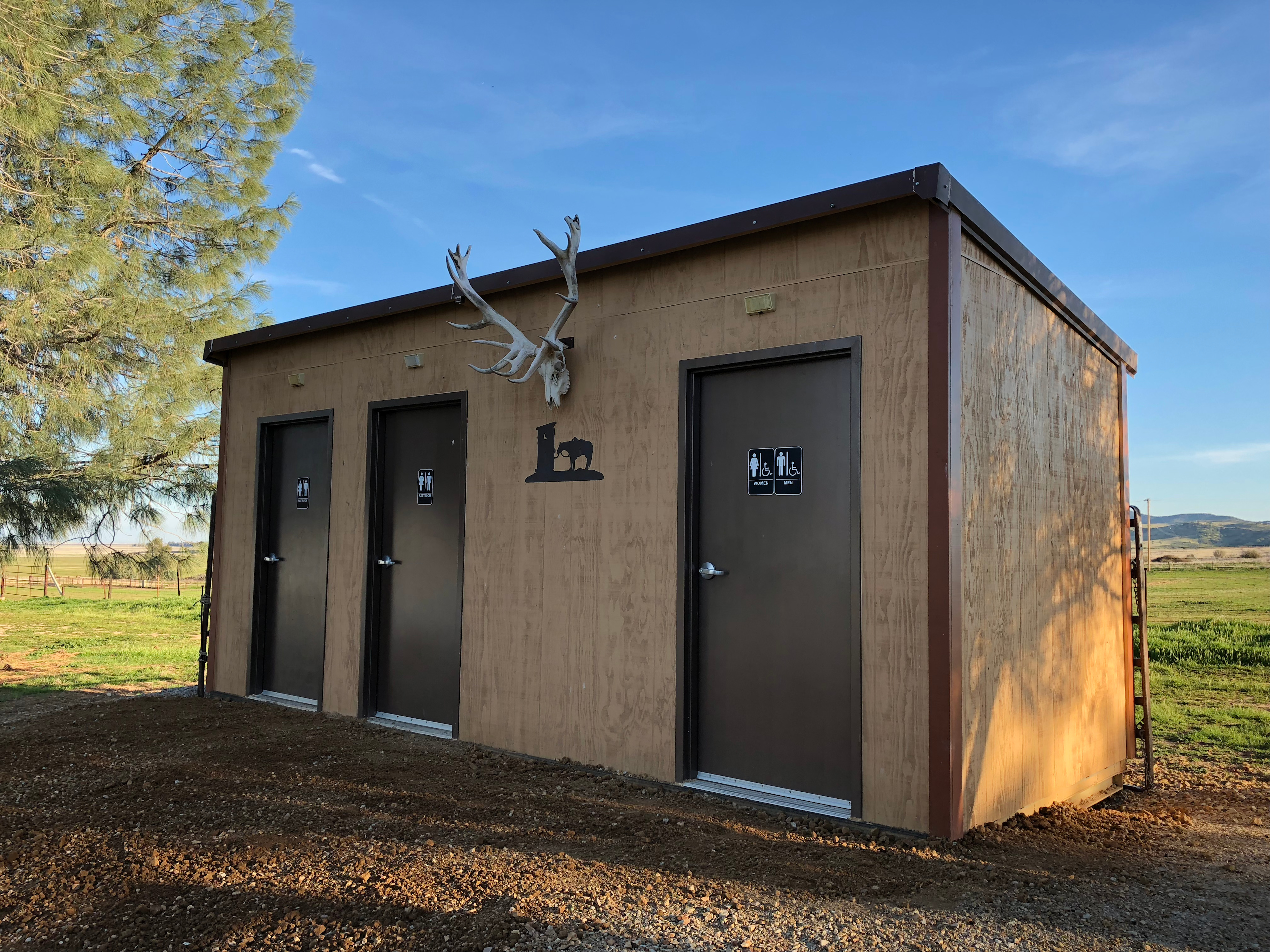 Beautiful three stall bathroom including handicap stall each with sink and mirror 