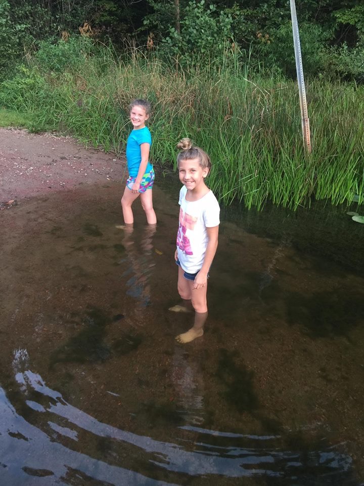 Trying to catch fish with their hands