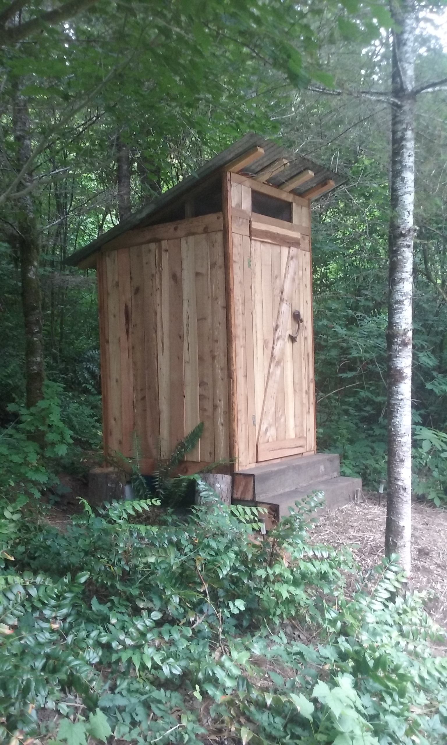 Outhouse with compostable tiolet is cleaned and checked daily and upon request.  Trash and recycling containers located nearby at edge of parking area.
