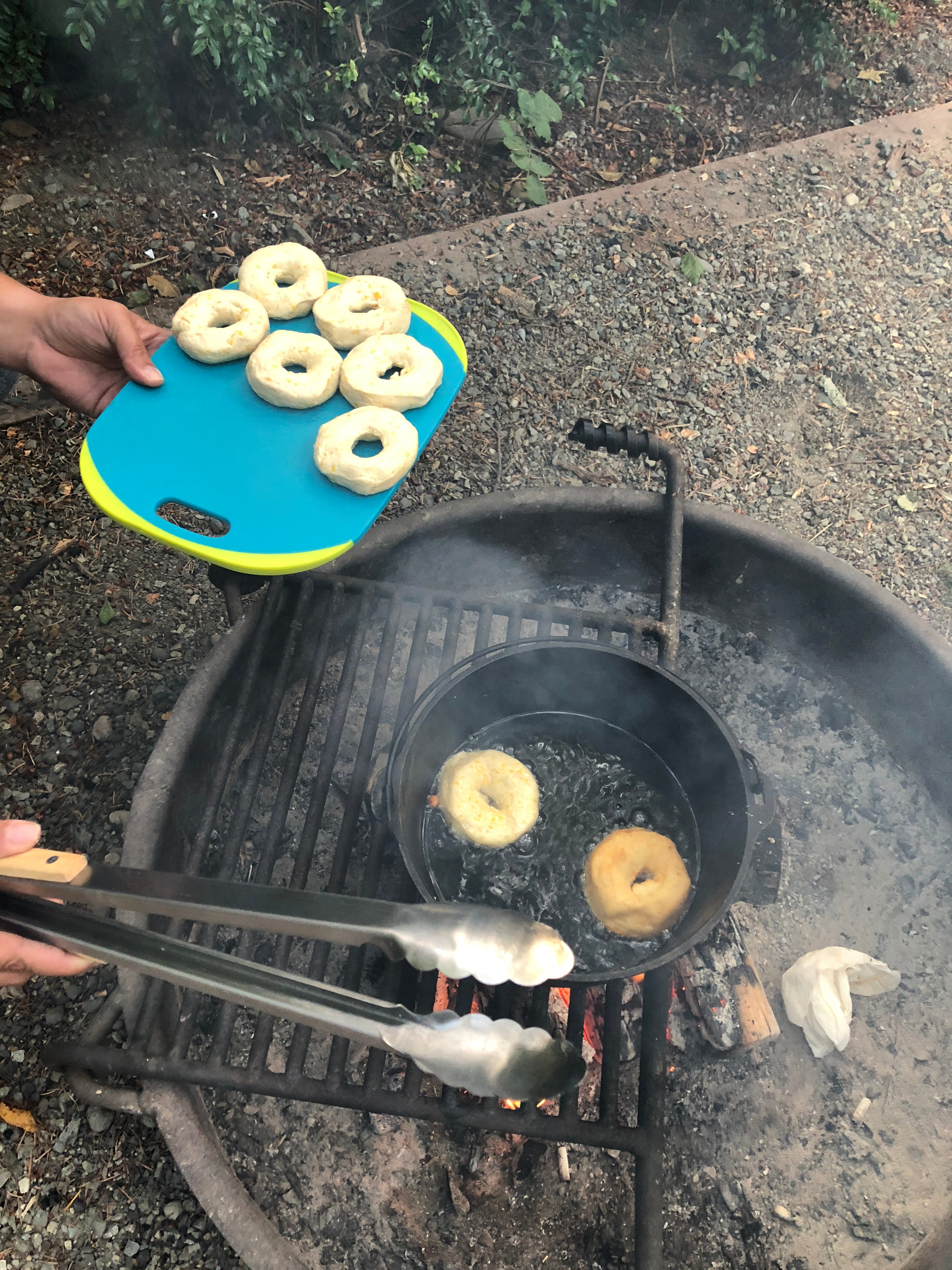 Each fire pit has a grate on a hinge that makes for easy cooking over the flames. When not needed it just flips over outside of the ring.