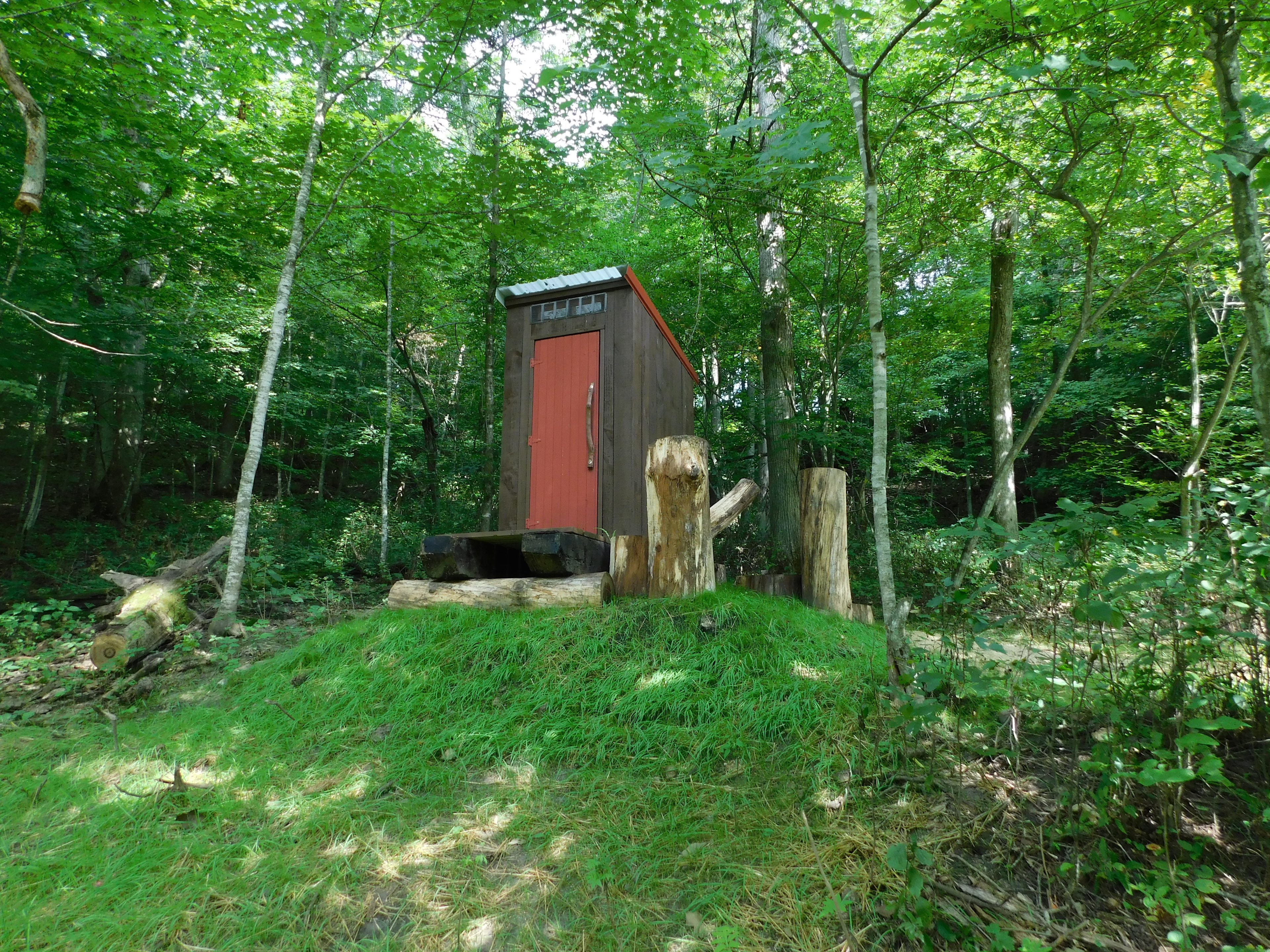 front view of outhouse, new grass seeding doing well.