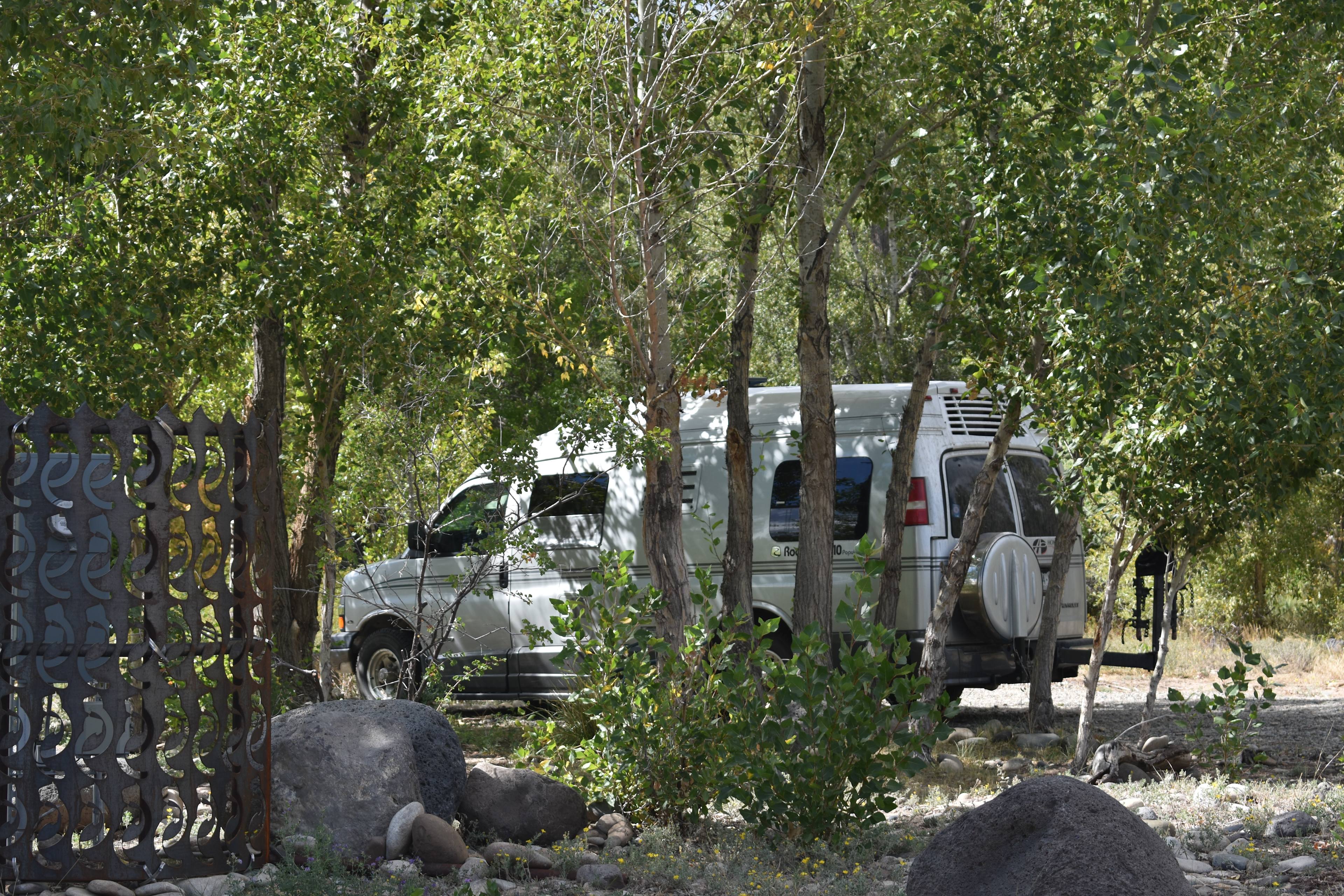 RV THAT IS 18' LONG UNDER THE CANOPY OF TREE.