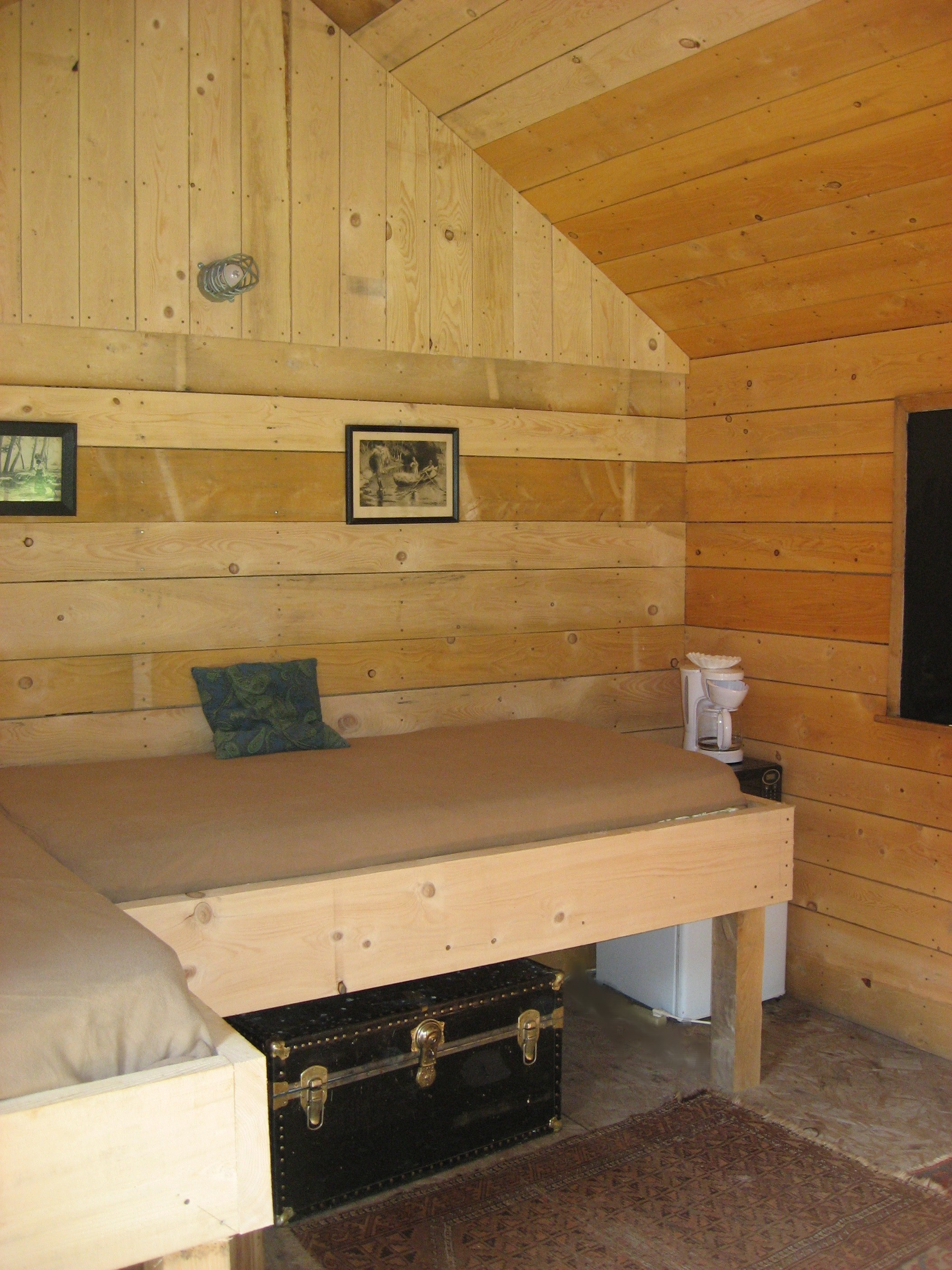 Two wide single beds that double as sitting areas