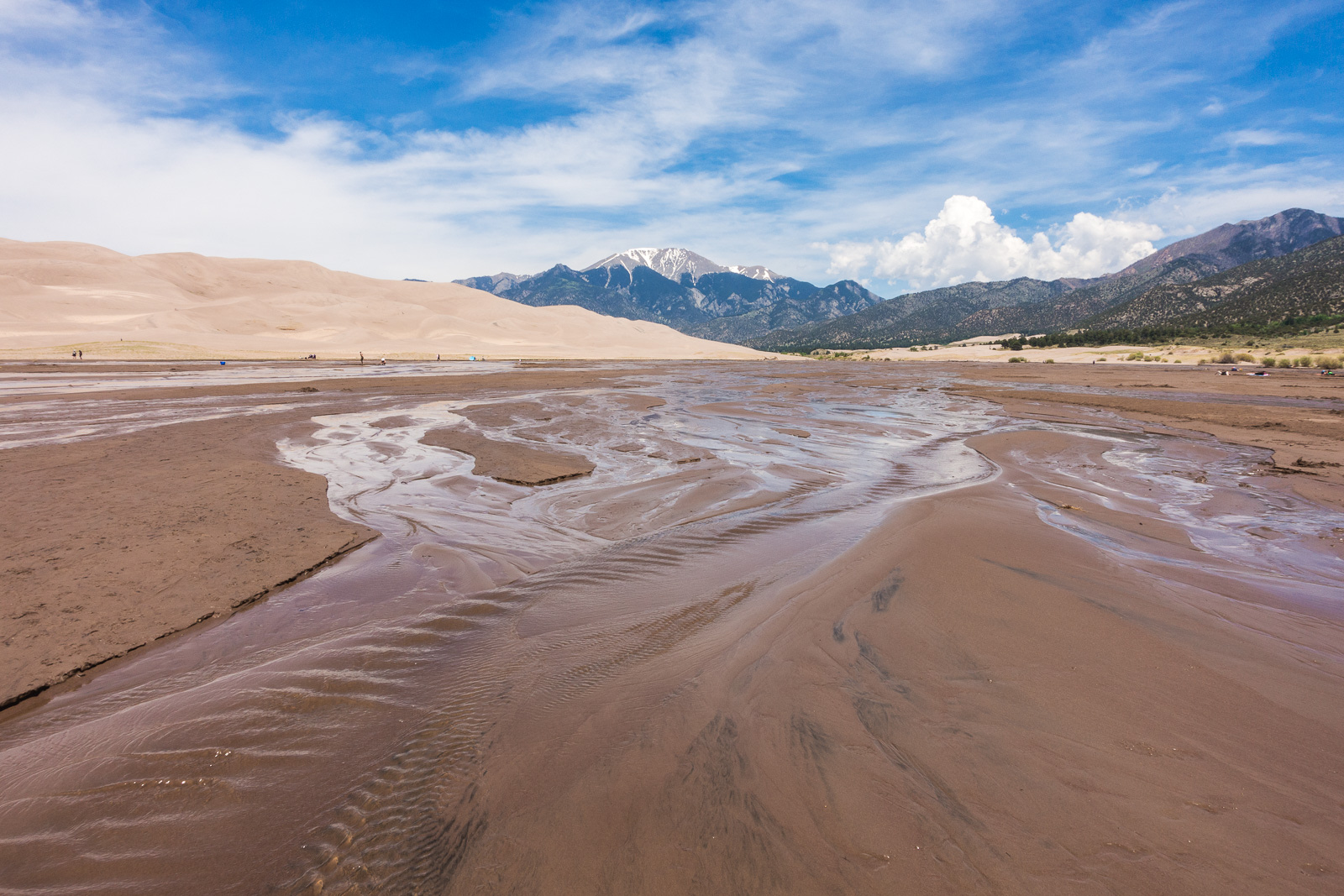 Snow melt from the mountains creates a beach area at the base of the dunes (this occurs between April and early June with the strongest flow typically late May to early June) in Great Sand Dunes National Park and Preserve.