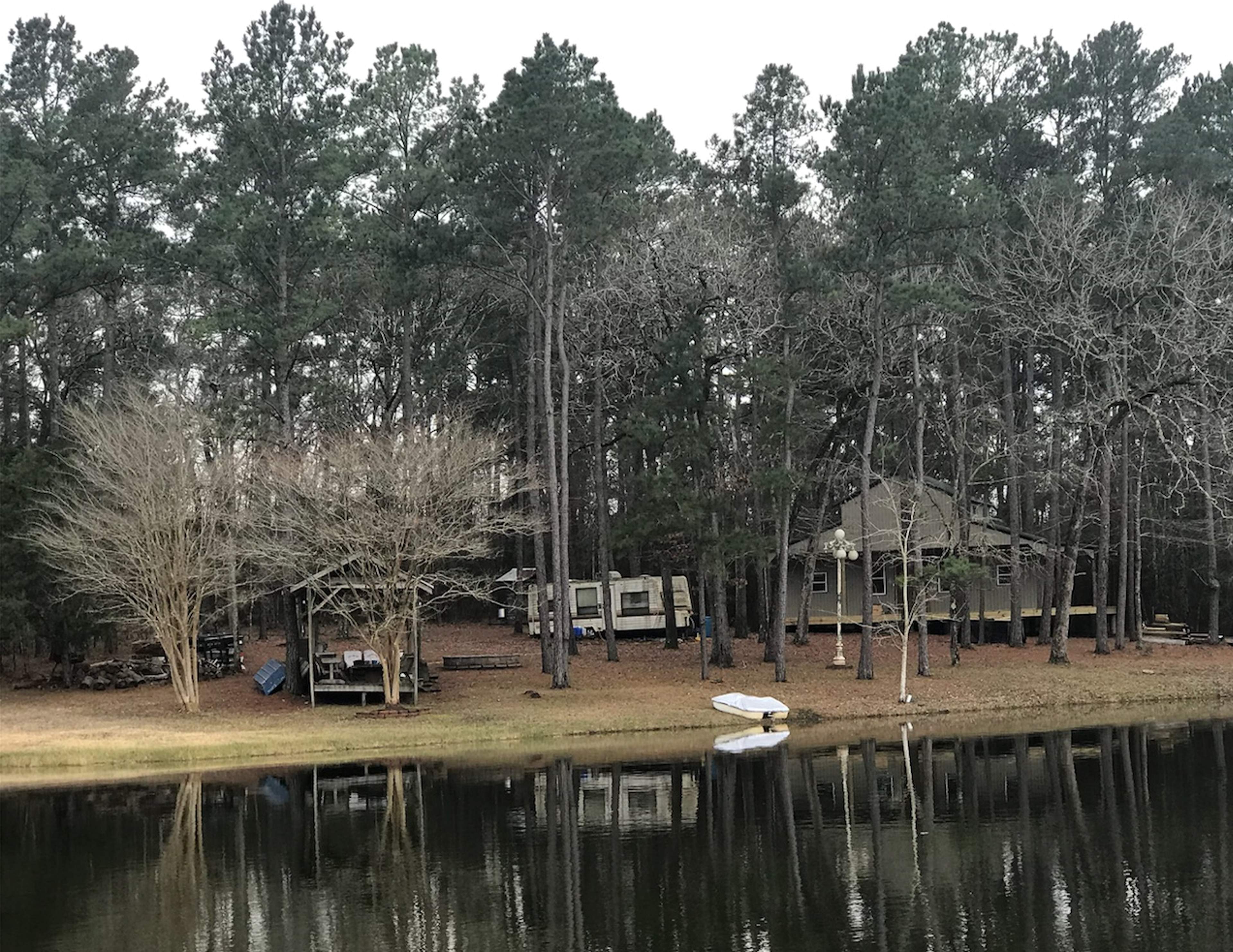 View of land from pond. The house in the background is still under construction. 