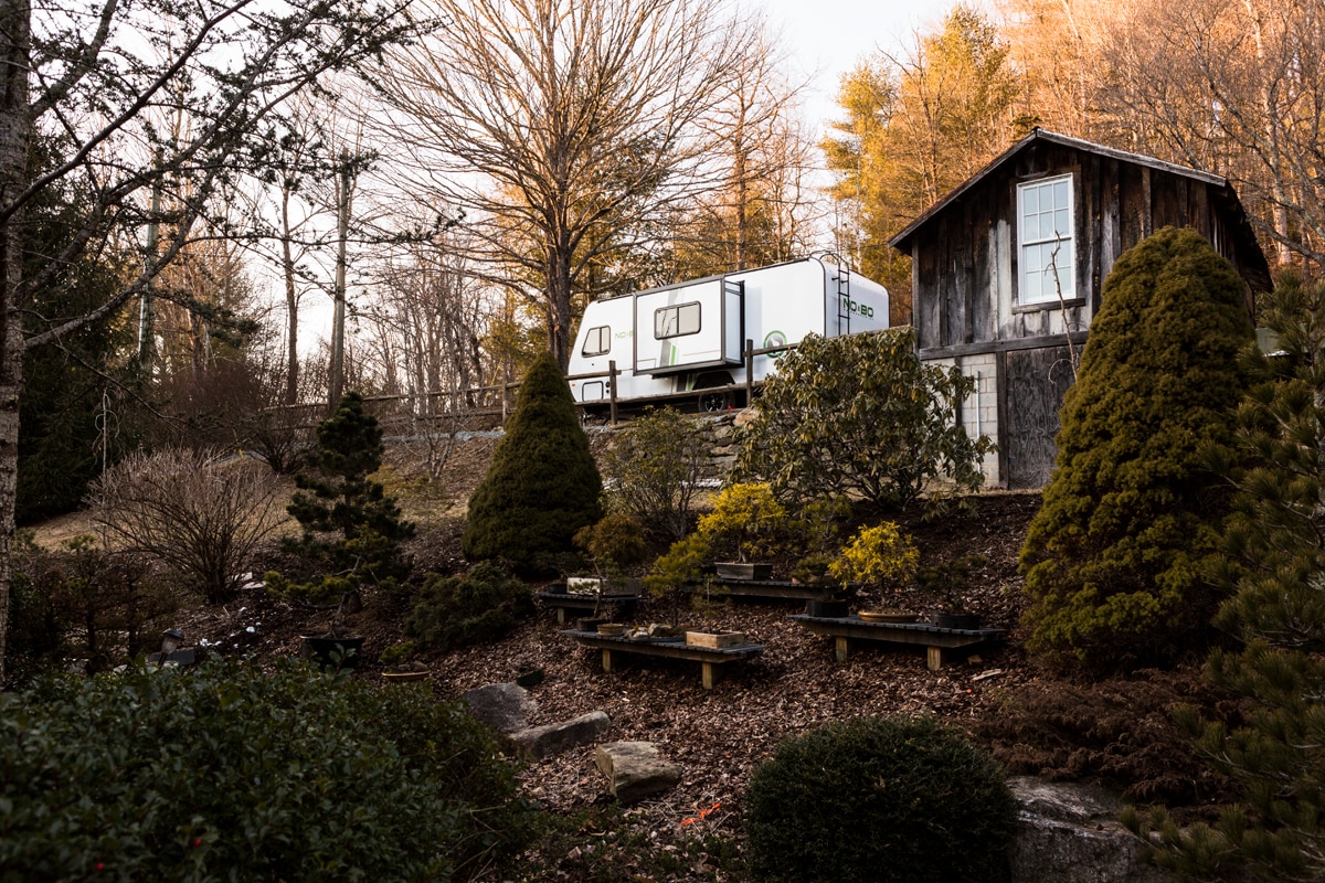 Beautiful landscaping and a bonsai garden separates us. 