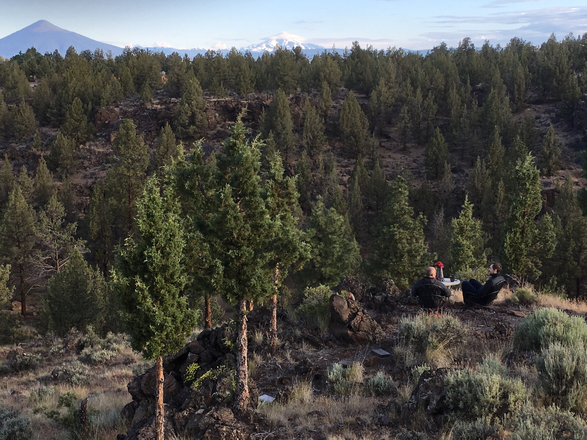 Campers enjoying breakfast over the cliffs and rock outcroppings