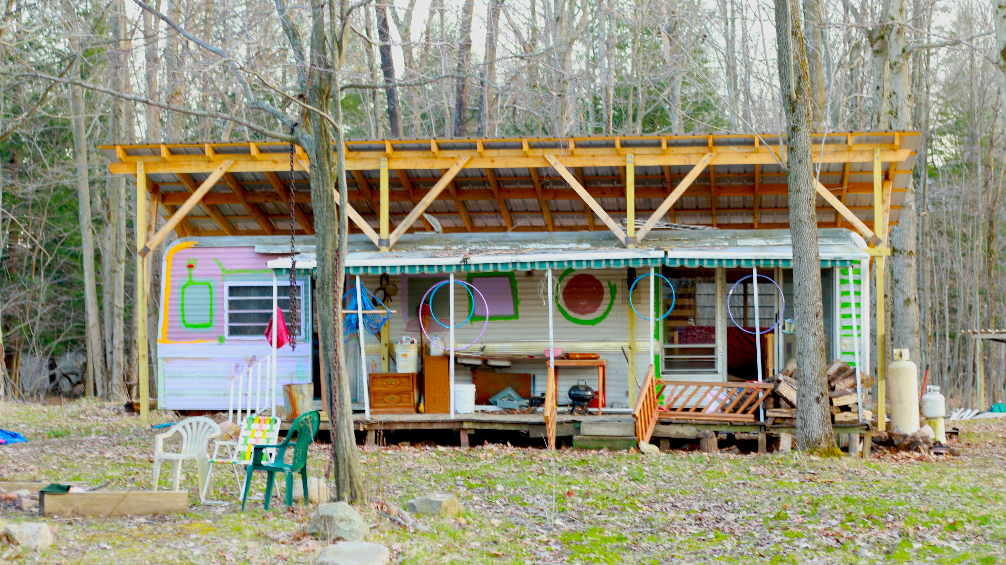 A frontal view of our work in progress.  As the summer moves forward we will be making more improvements and creating more and more beautiful artwork, cleaning up the land and planting more flowers and trees,  We may even stock our little ponds with fish!