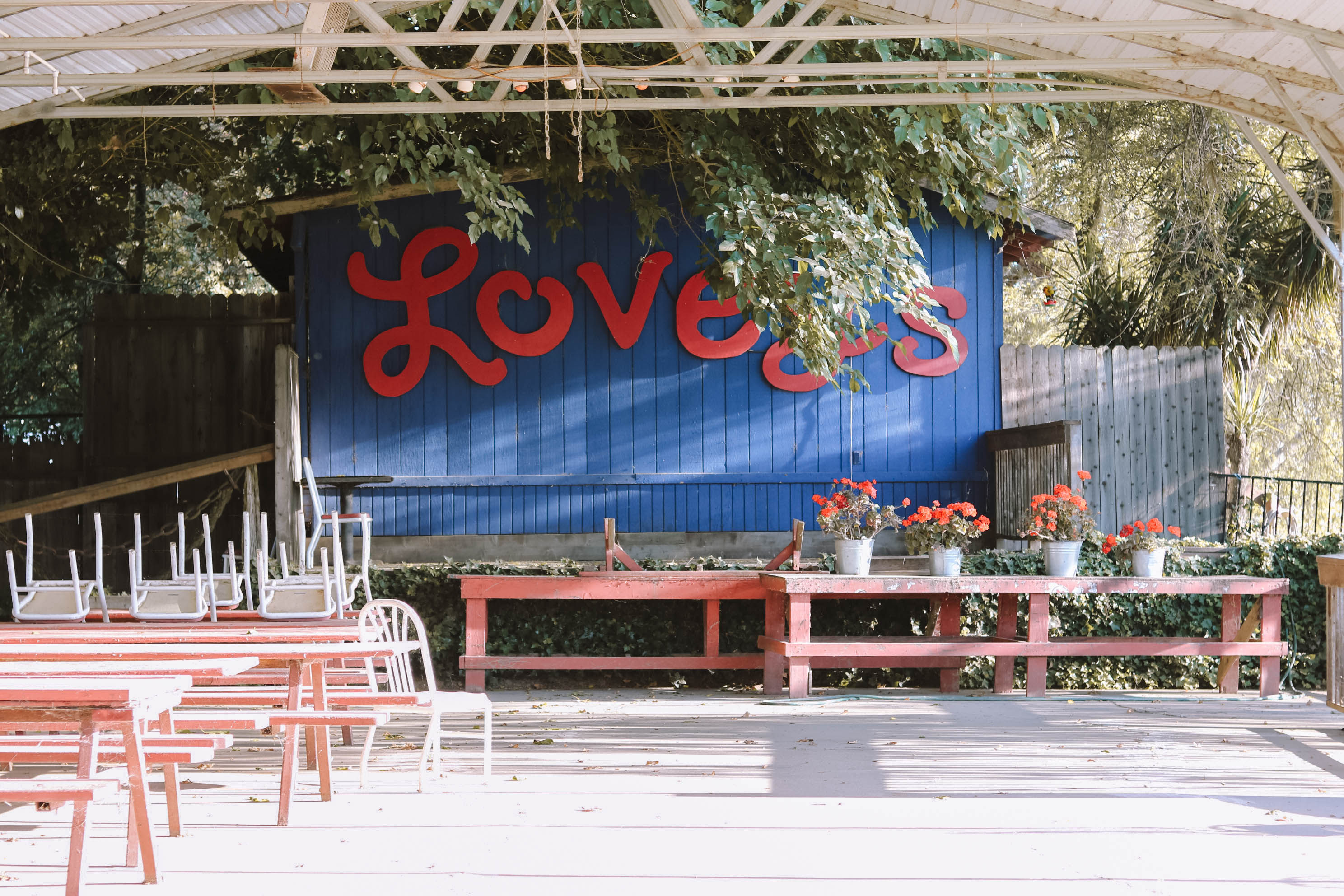 Covered community gathering space between the restaurant and the river