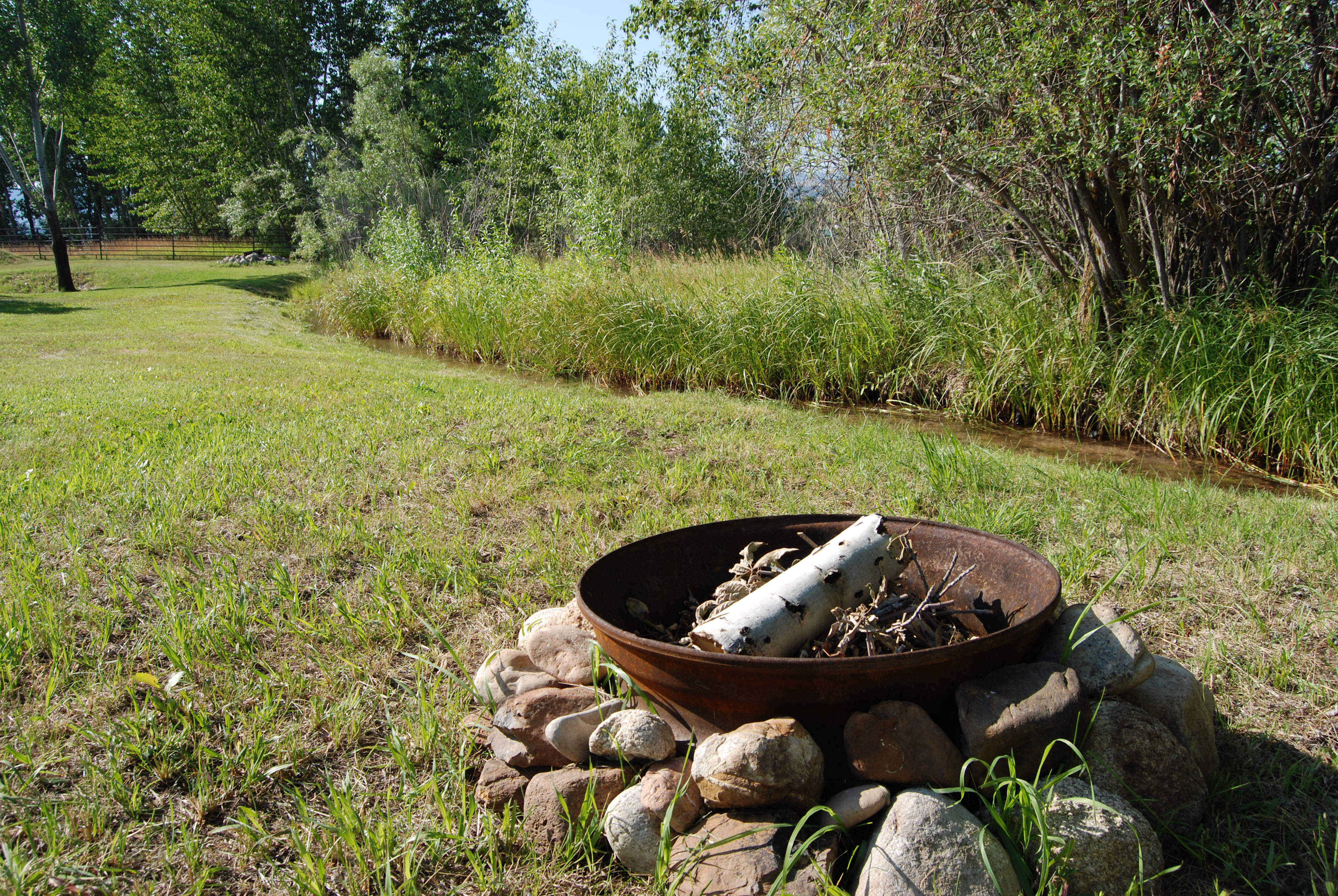 A firepit next to the stream and picnic table for your enjoyment.