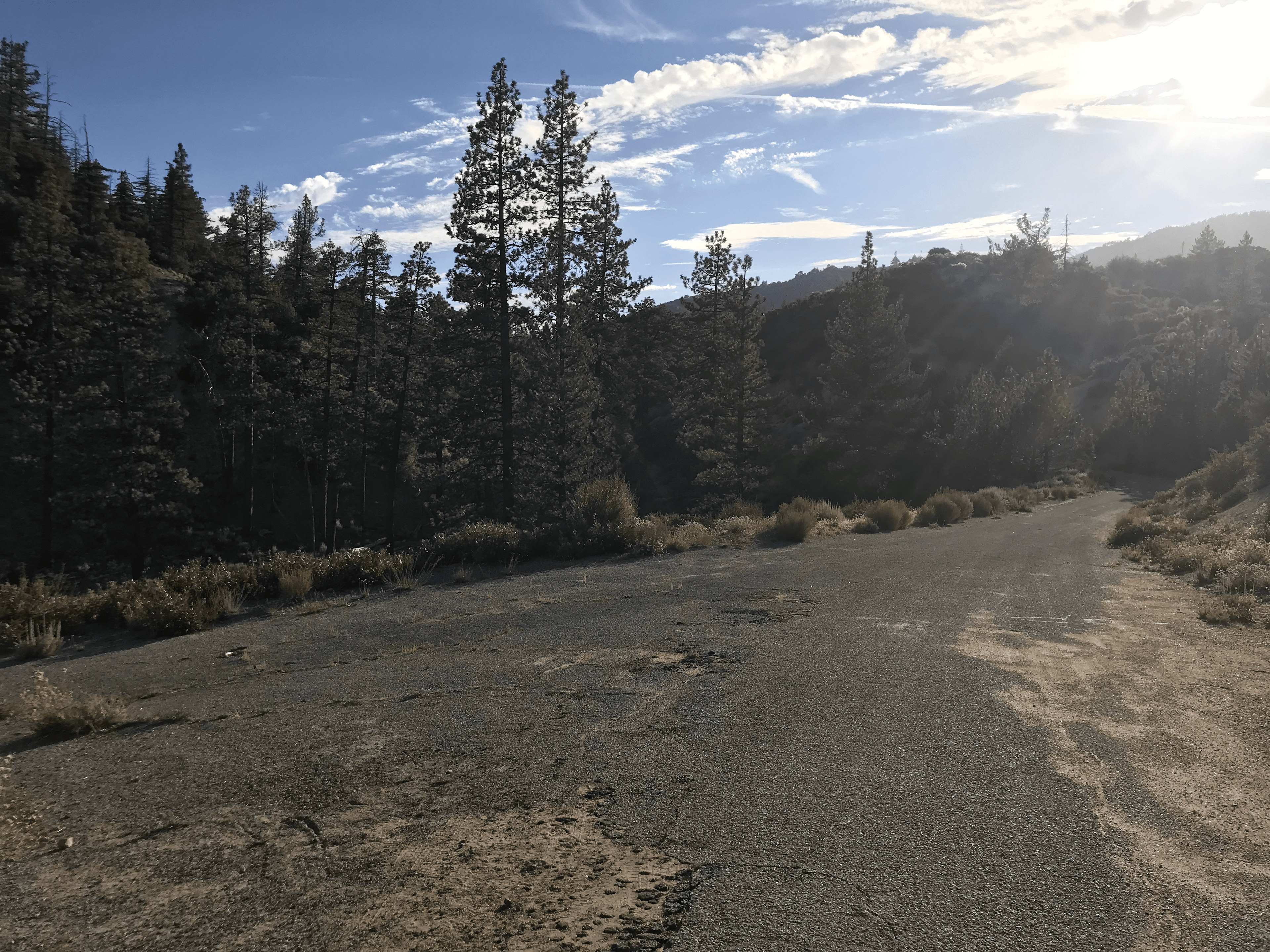 Standing in the "parking lot". Road to drive in is on the right, gated road down to the campsite is to the left.